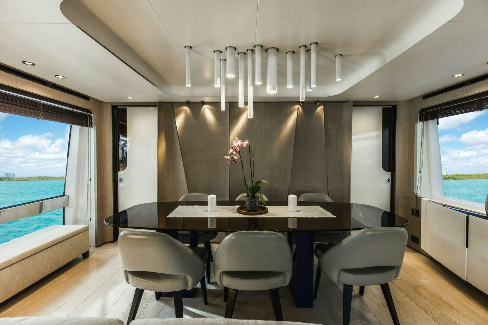 a room with a table and chairs aboard MAJESTIC MOMENTS Yacht for Sale