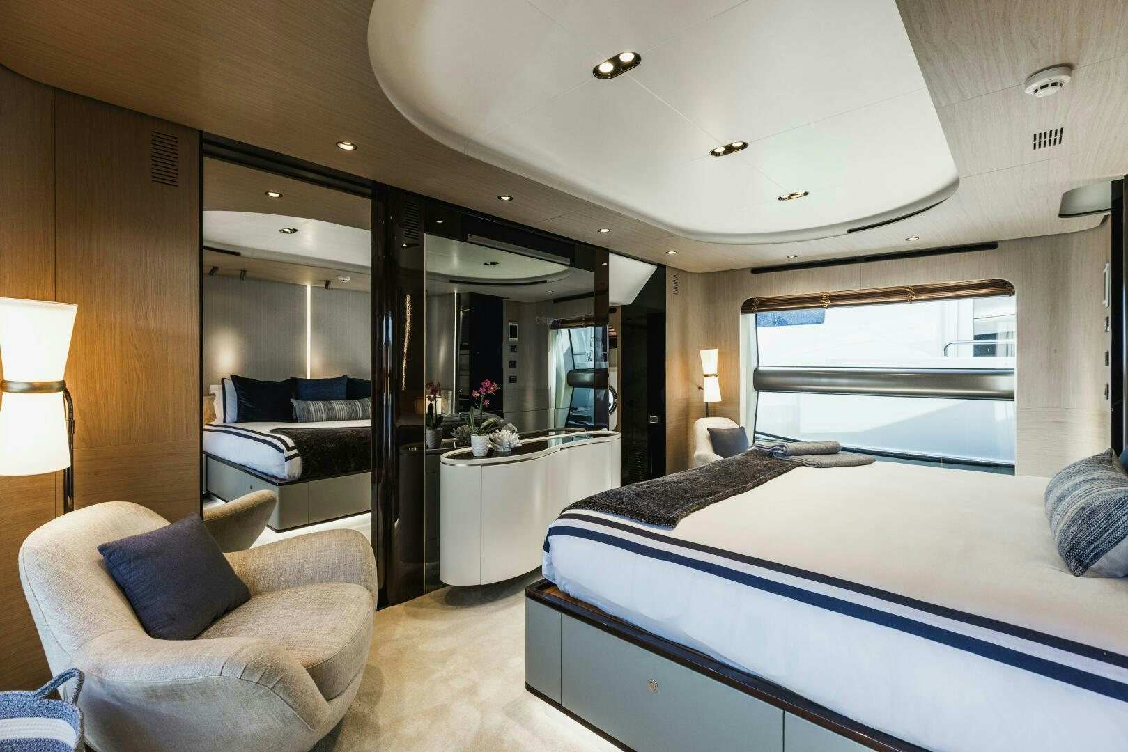 a bedroom with a bed and a chair aboard MAJESTIC MOMENTS Yacht for Sale