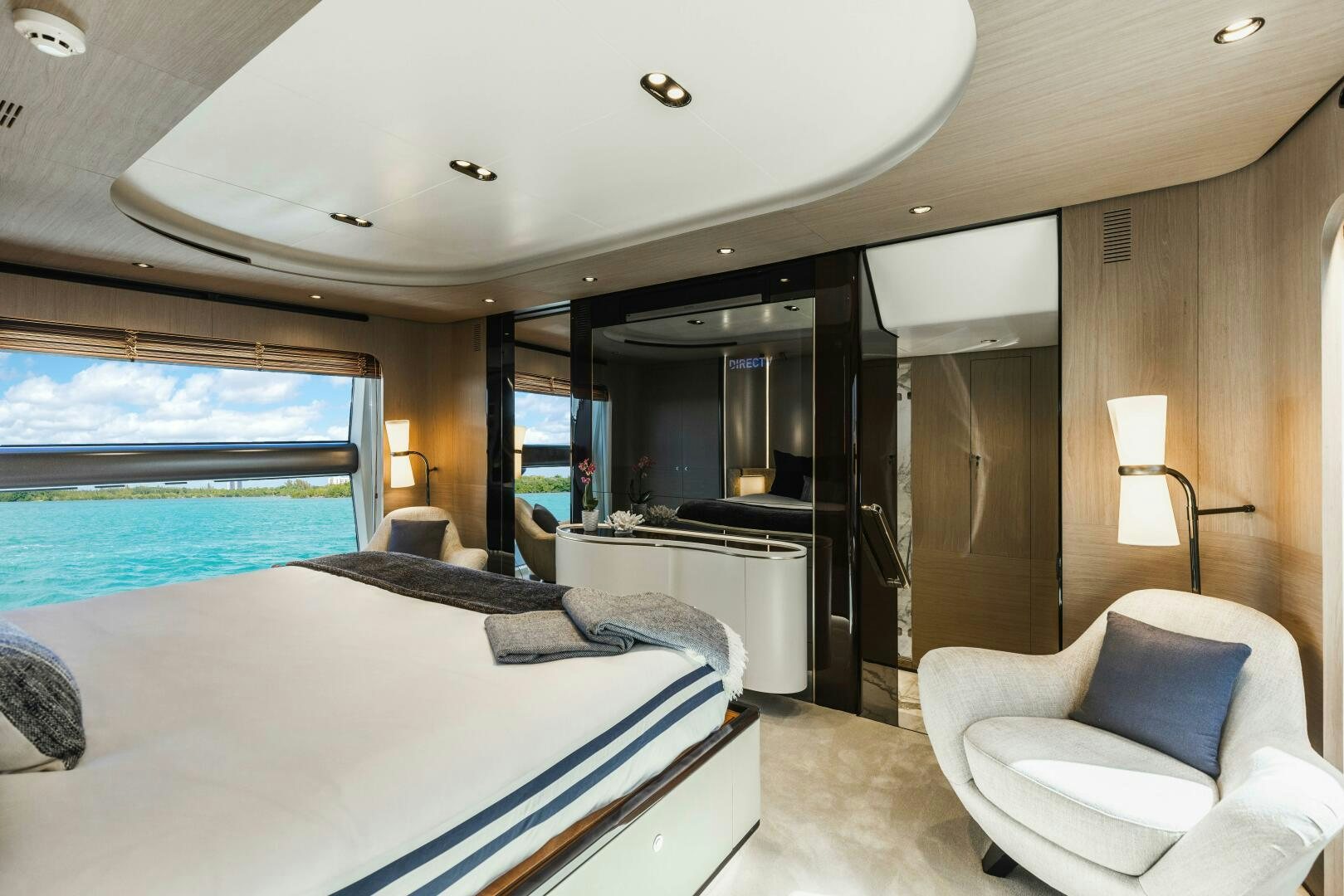a hotel room with a bed and a chair aboard MAJESTIC MOMENTS Yacht for Sale