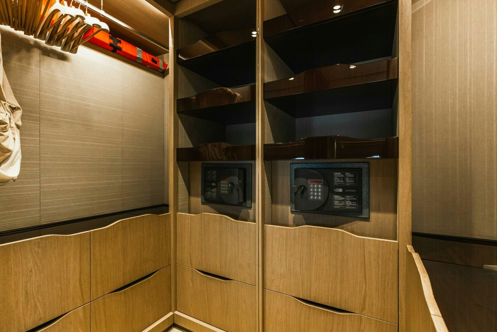 a wooden cabinet with a black box and a red pen on it aboard MAJESTIC MOMENTS Yacht for Sale