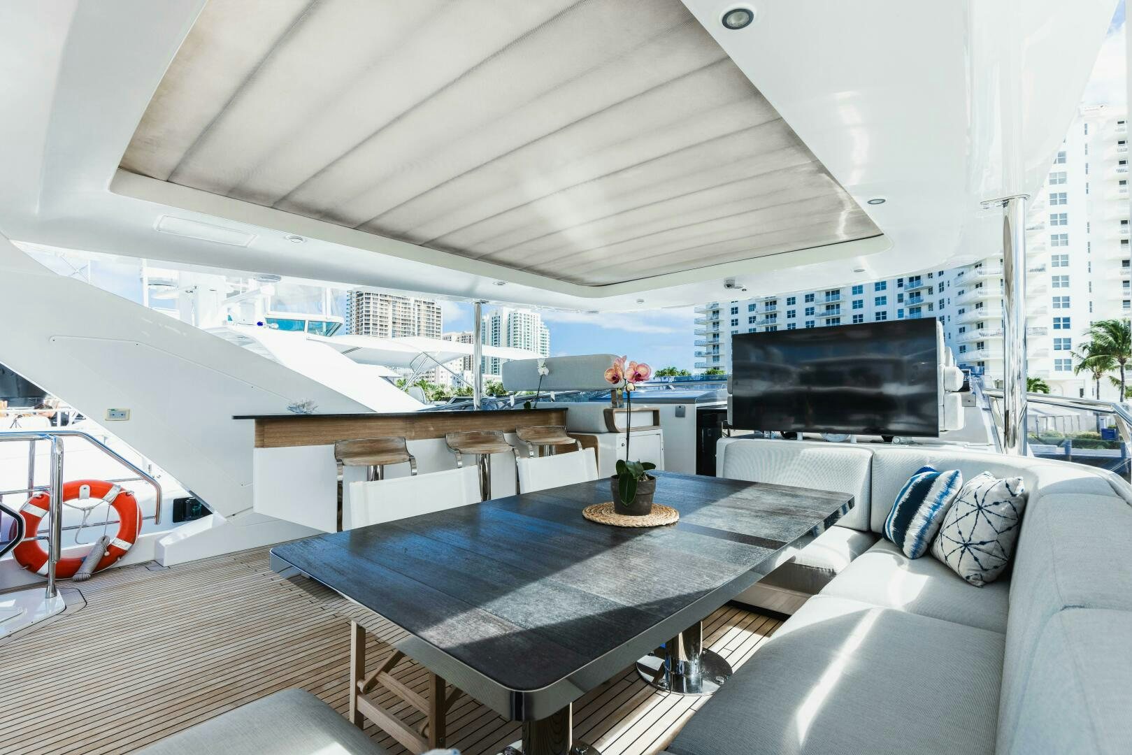 a room with a table and a couch aboard MAJESTIC MOMENTS Yacht for Sale