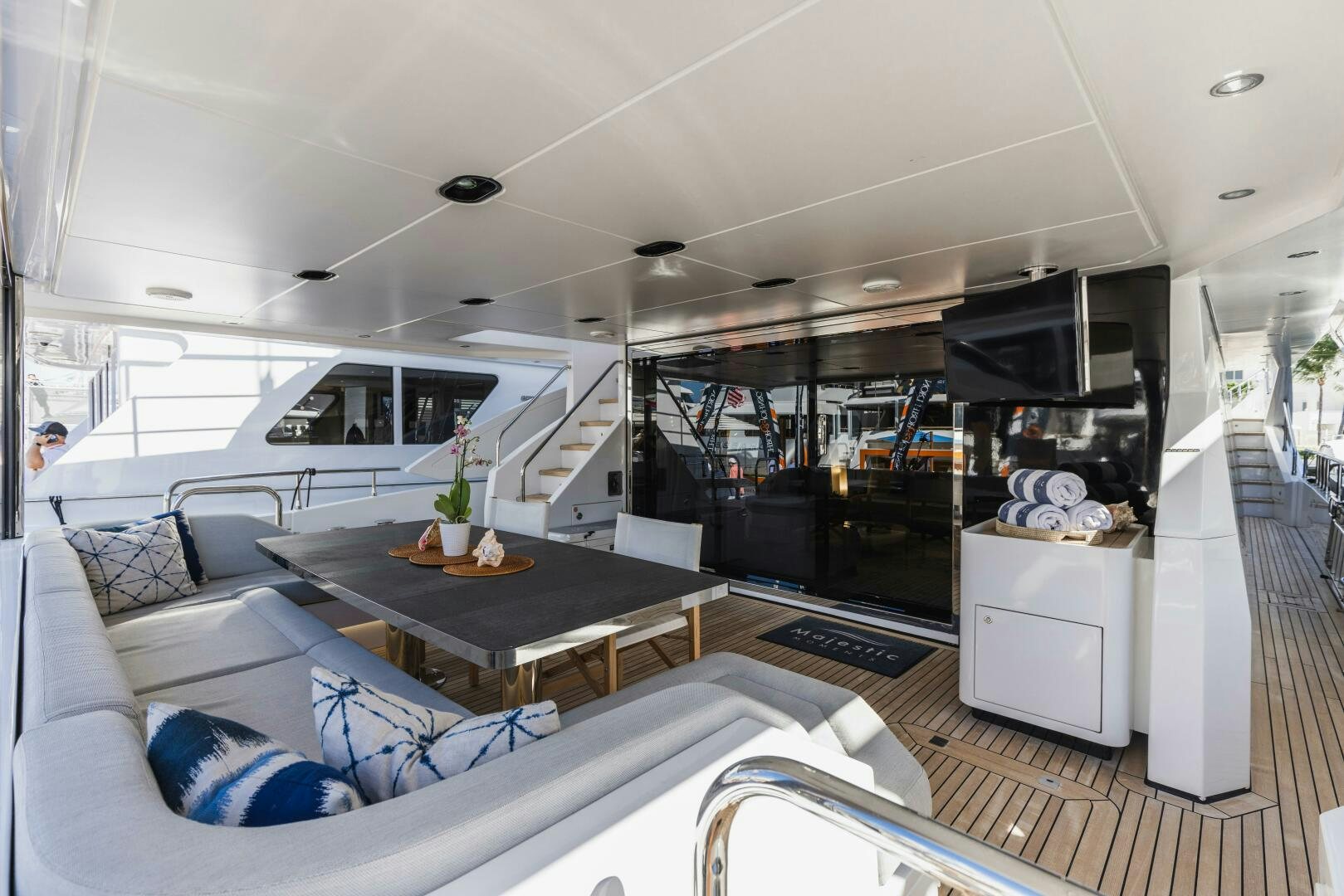 a living room with a large white sofa and a coffee table aboard MAJESTIC MOMENTS Yacht for Sale