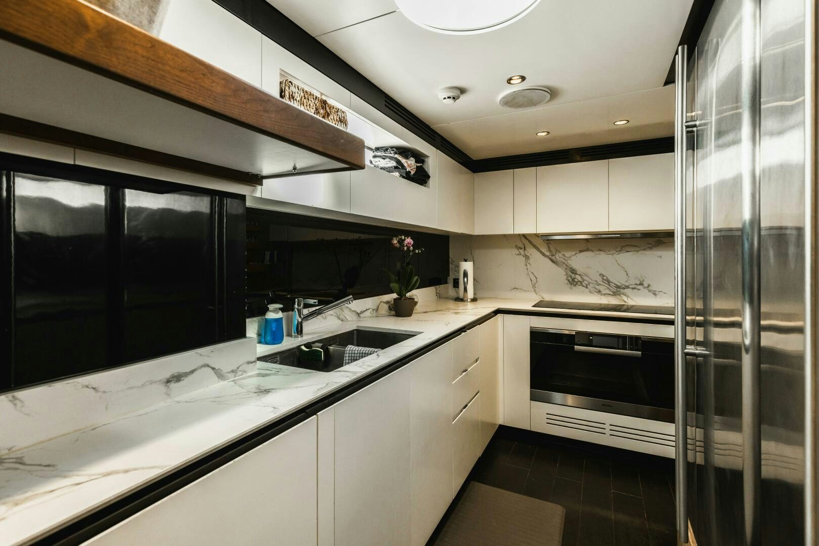 a kitchen with a glass shower aboard MAJESTIC MOMENTS Yacht for Sale