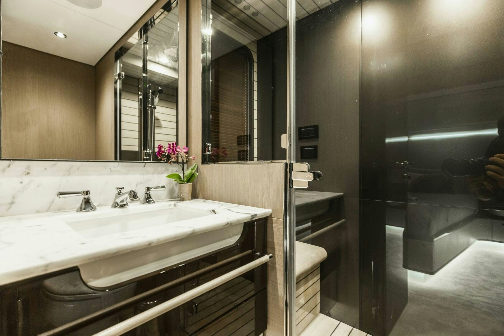 a bathroom with a sink and a mirror aboard MAJESTIC MOMENTS Yacht for Sale