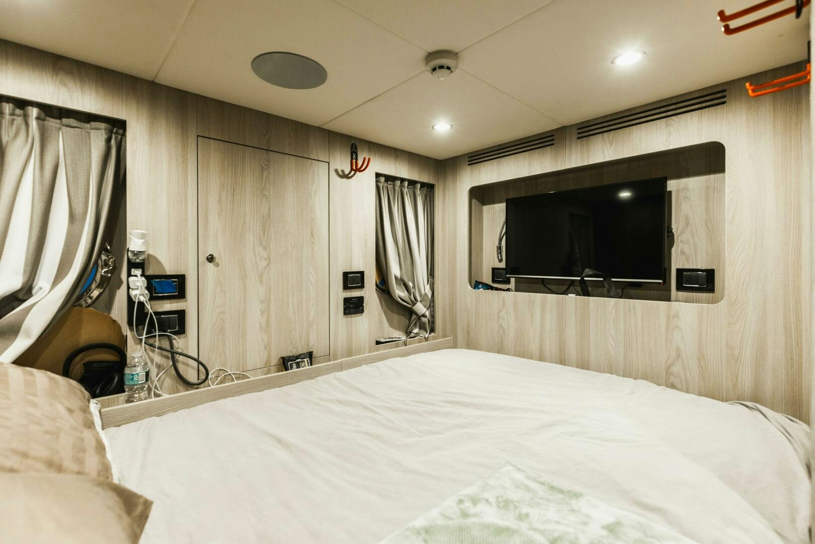 a bedroom with a television and a bed aboard MAJESTIC MOMENTS Yacht for Sale