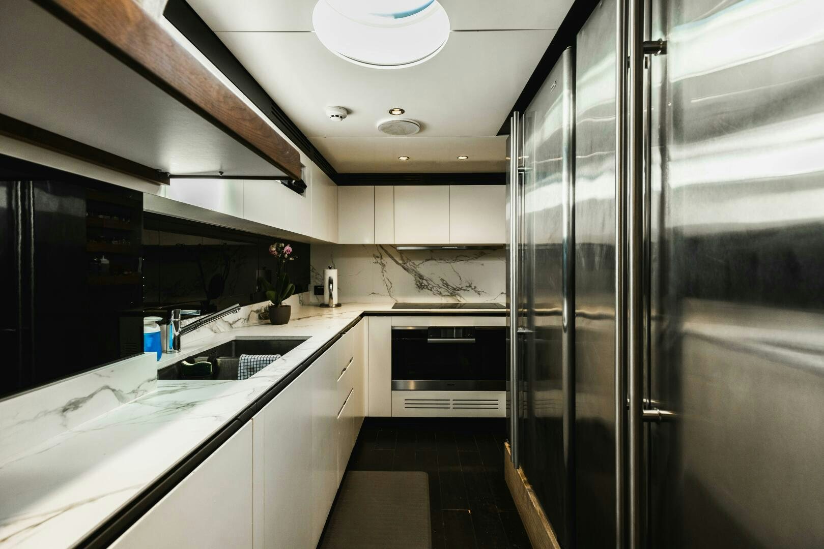 a kitchen with a glass door aboard MAJESTIC MOMENTS Yacht for Sale