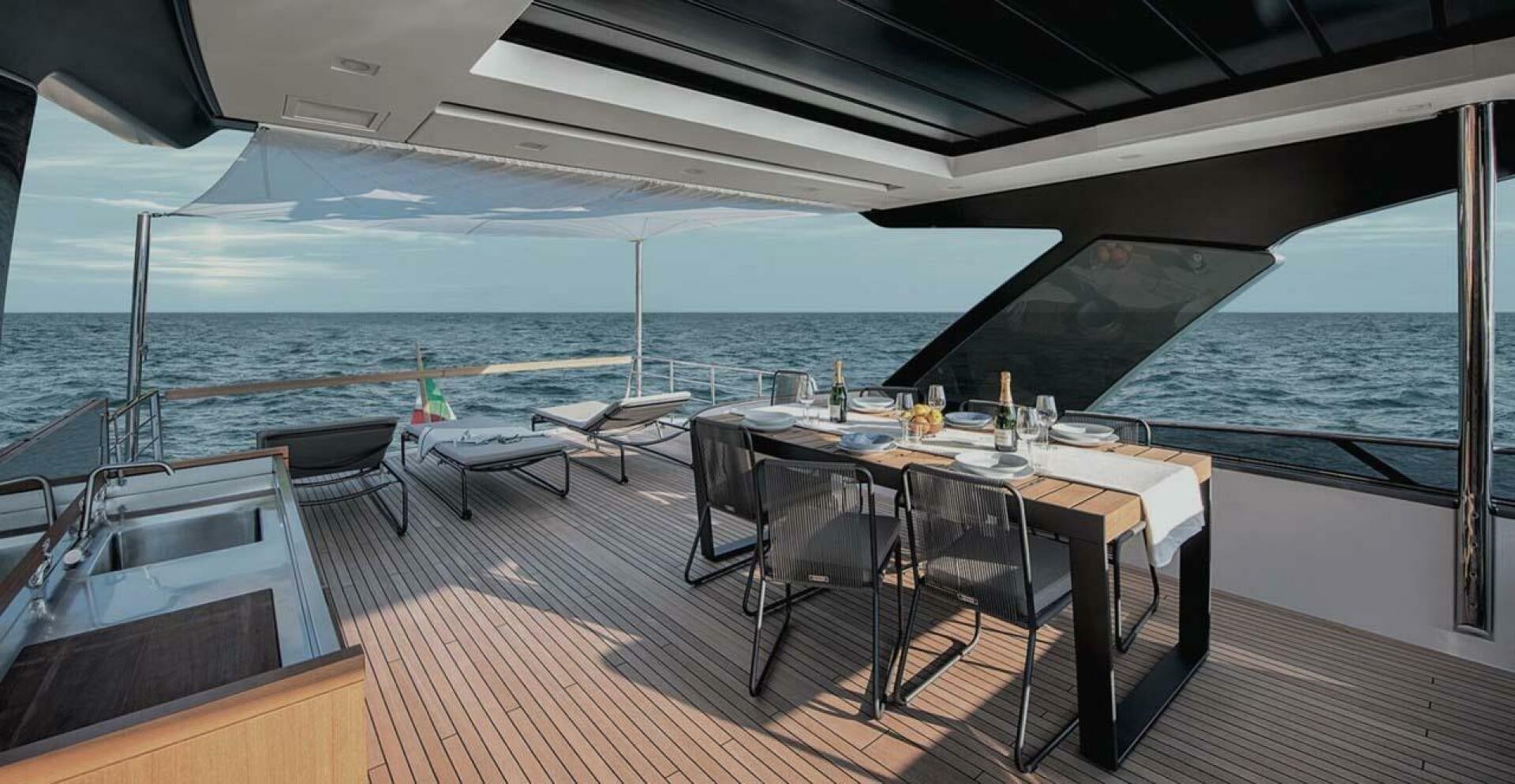 a table on a deck overlooking the ocean aboard SIGNE Yacht for Sale