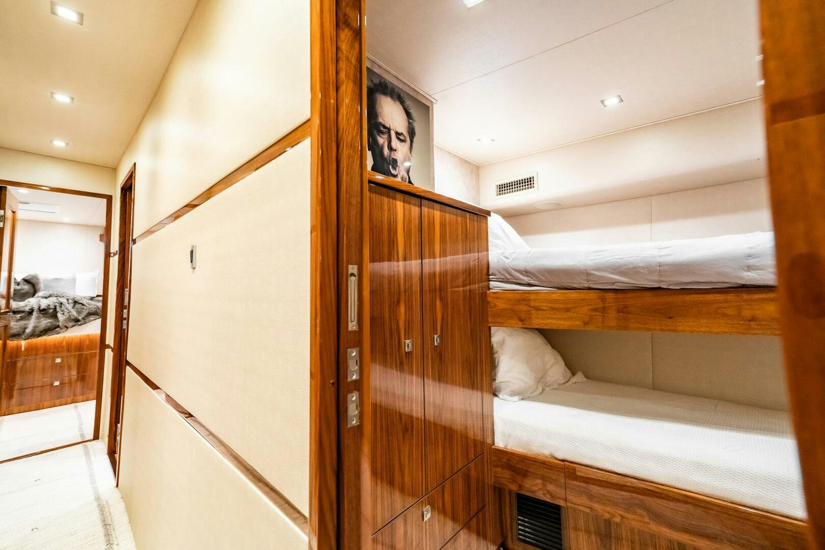 a room with a bed and a wood door aboard FRIGATE Yacht for Sale