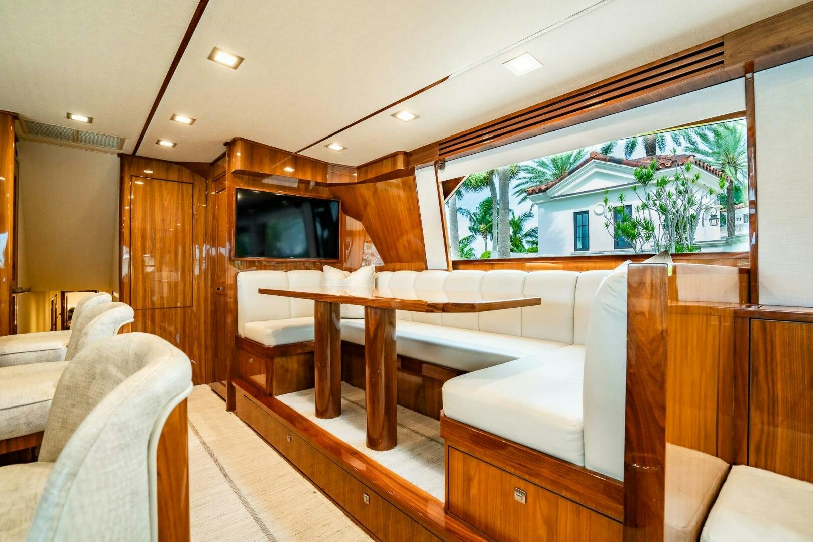 a room with a table and couches aboard FRIGATE Yacht for Sale