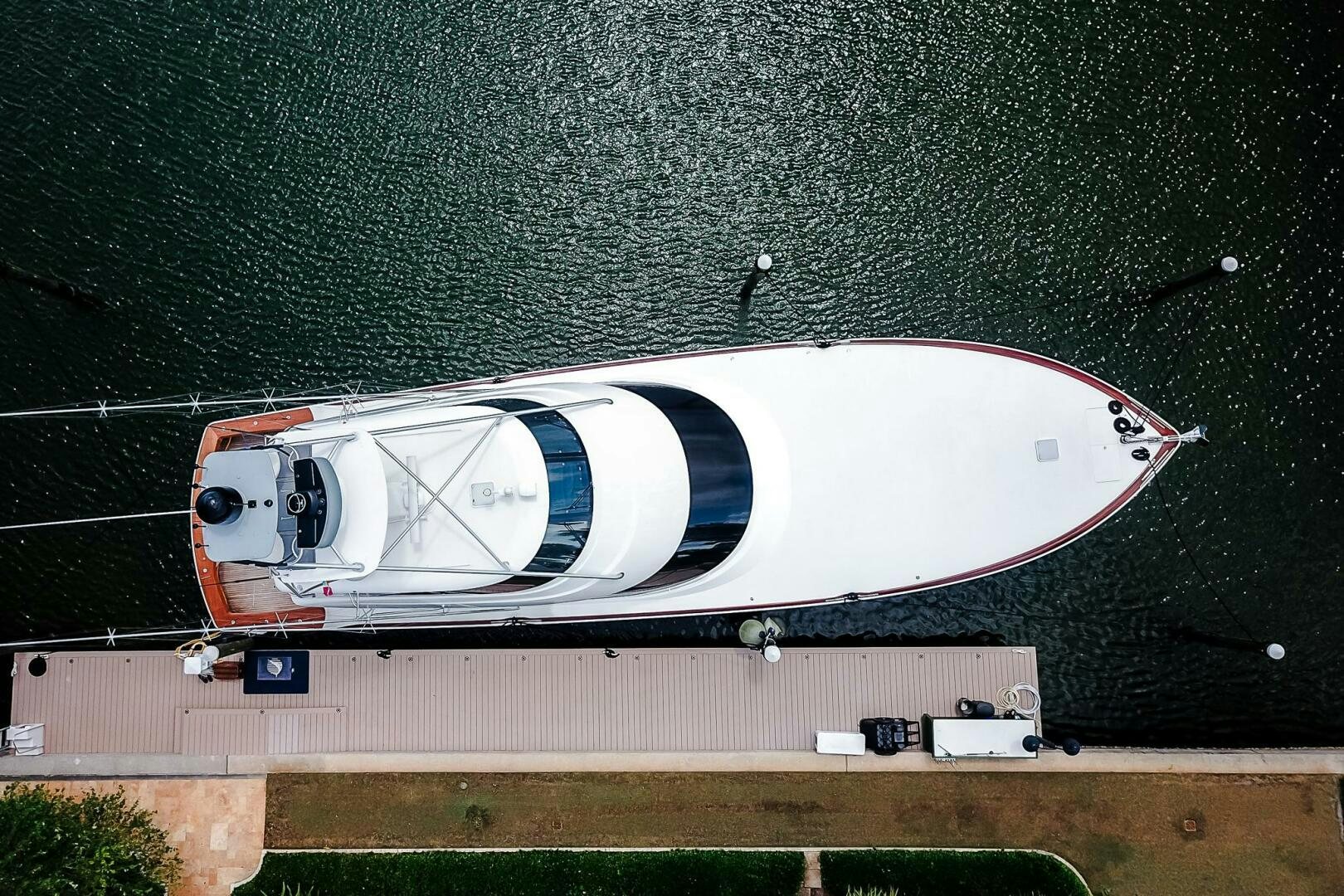 a white boat on a dock aboard FRIGATE Yacht for Sale