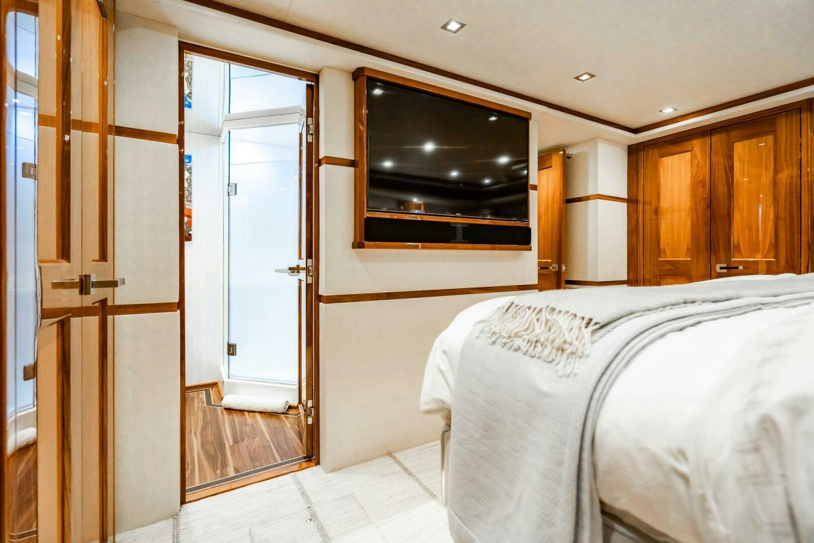 a bedroom with a bed and a television aboard FRIGATE Yacht for Sale