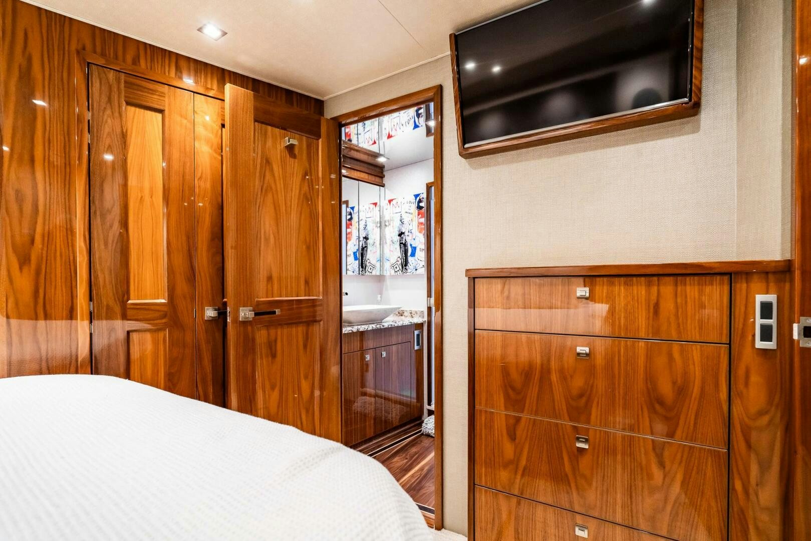 a bedroom with a bed and a television aboard FRIGATE Yacht for Sale