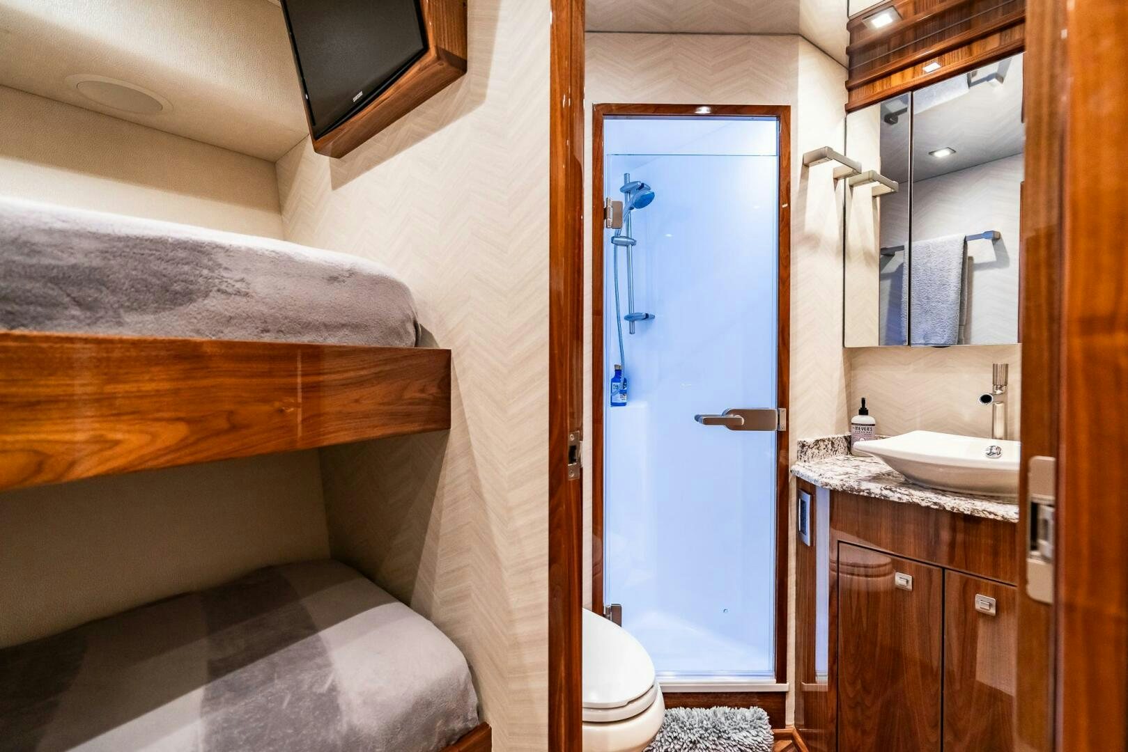 a bathroom with a bed and a sink aboard FRIGATE Yacht for Sale