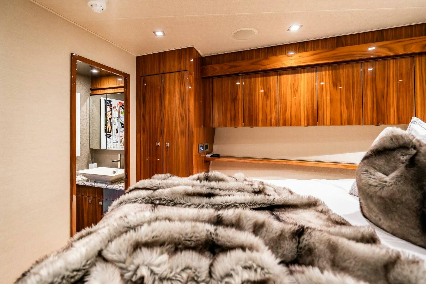 a bedroom with a large mirror aboard FRIGATE Yacht for Sale