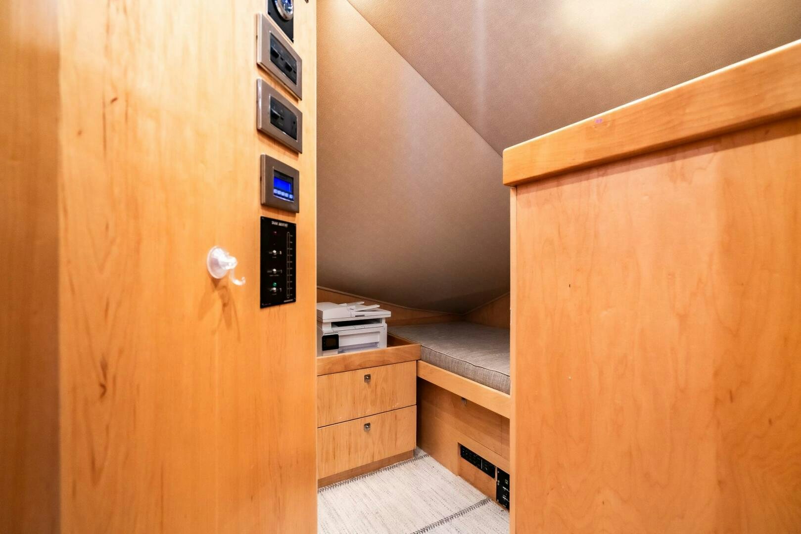 a wooden cabinet with a white handle aboard FRIGATE Yacht for Sale