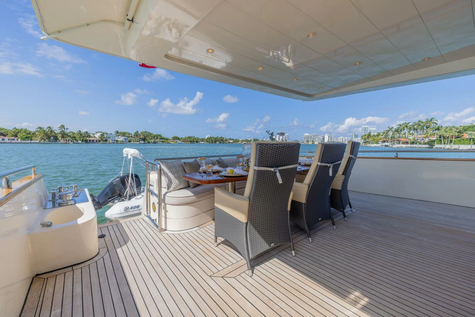 a deck with a table chairs and a pool aboard BOULOS Yacht for Sale