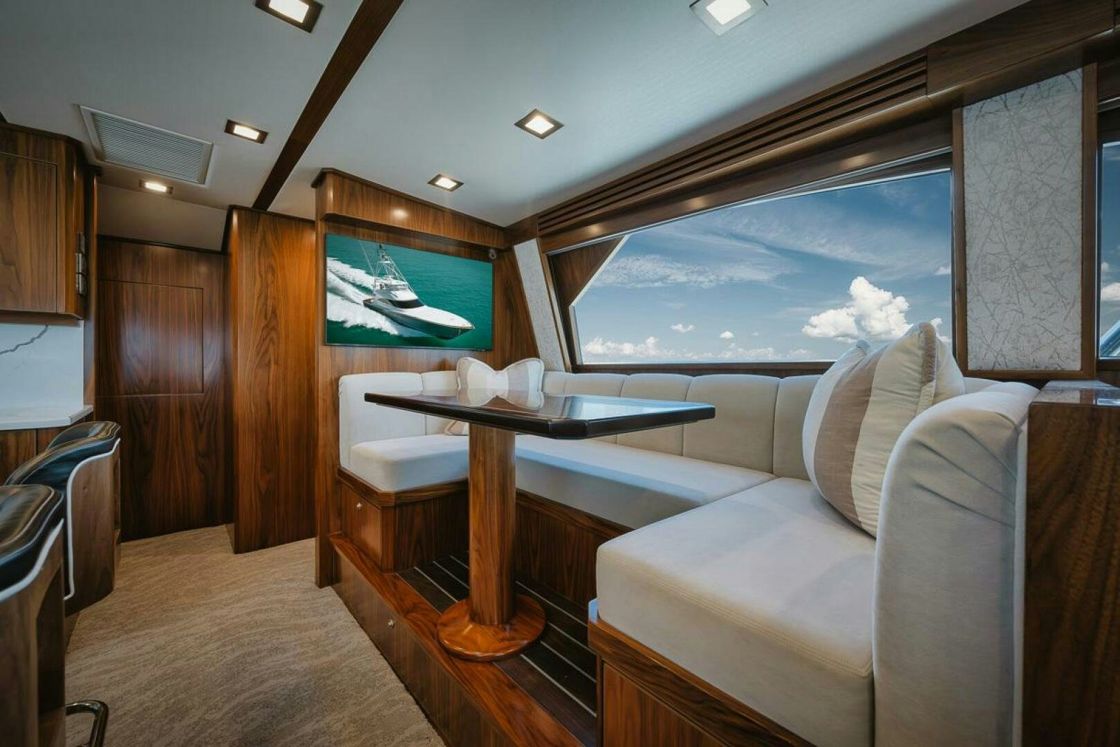 a room with a couch and a table and a television aboard WHIRLWIND Yacht for Sale