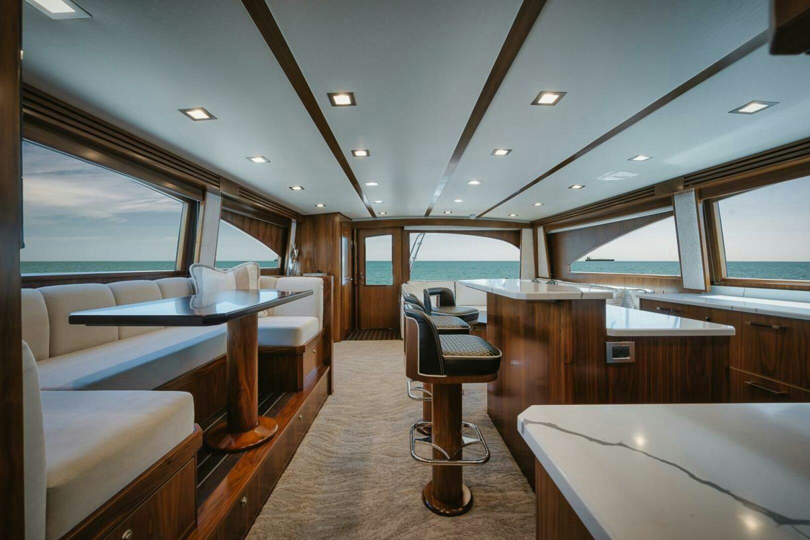 a room with a table chairs and a large window aboard WHIRLWIND Yacht for Sale
