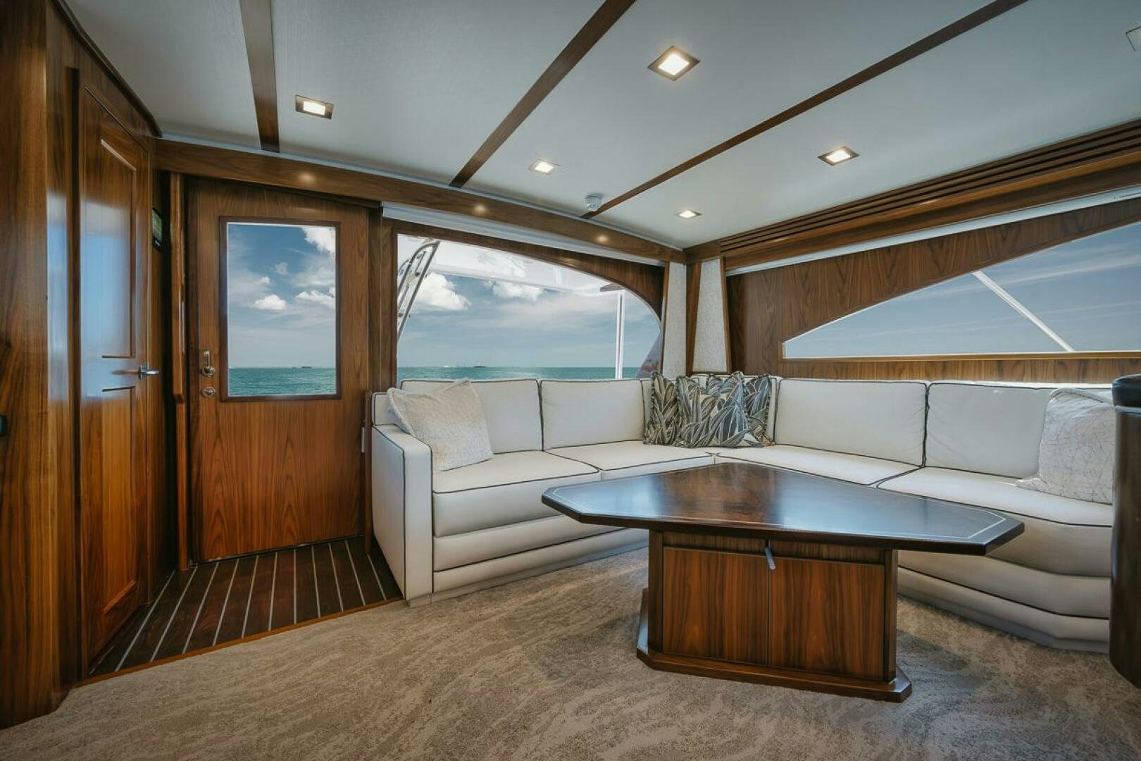 a living room with a table and couches aboard WHIRLWIND Yacht for Sale