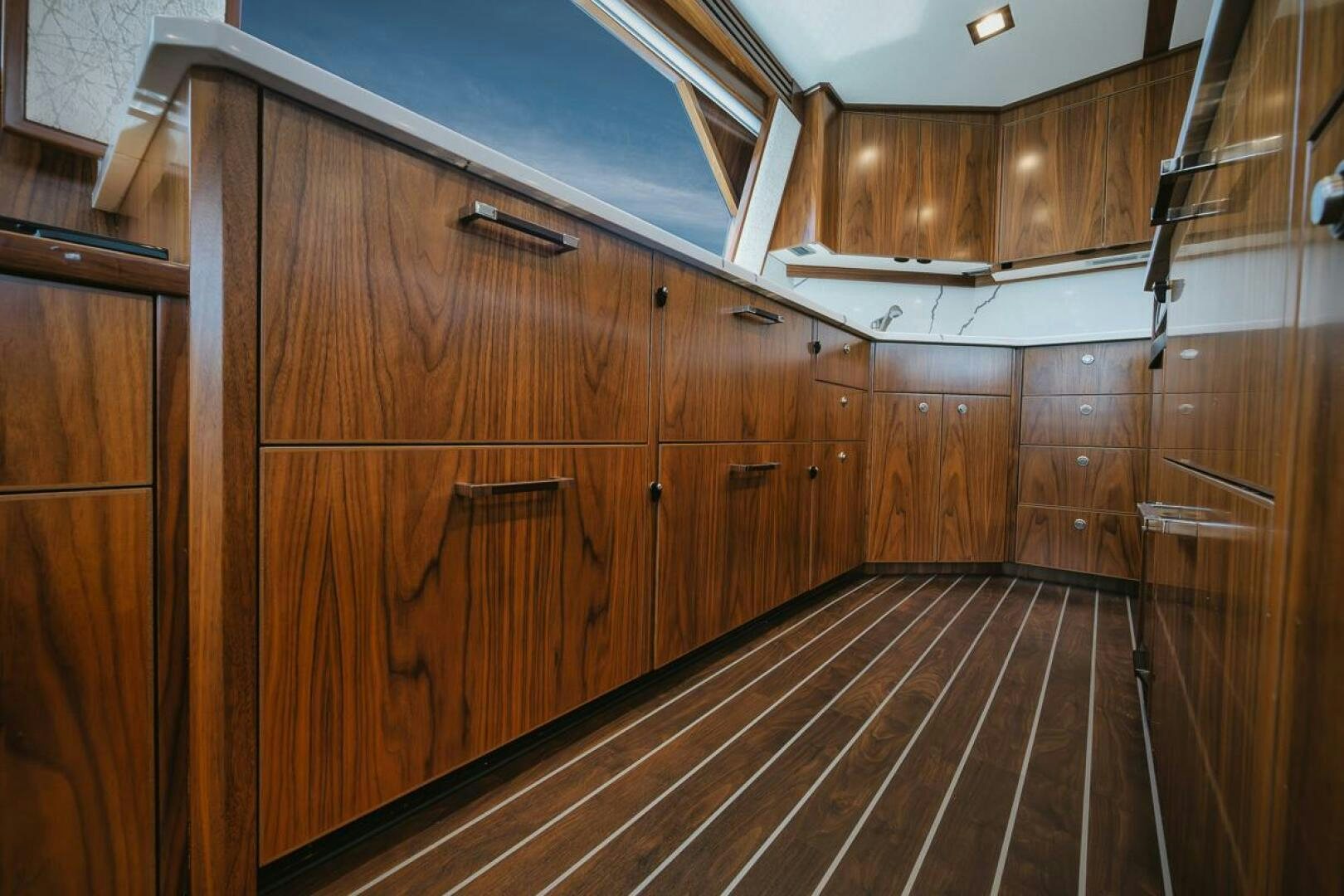 a wooden cabinet with a glass door aboard WHIRLWIND Yacht for Sale