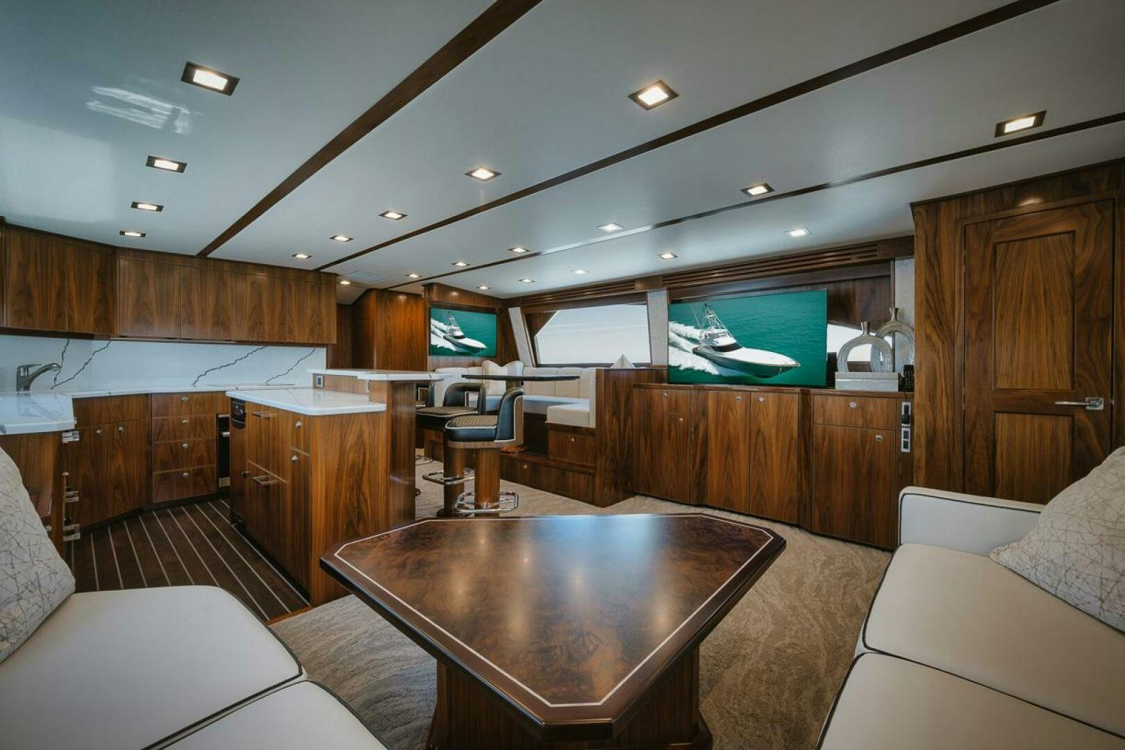 a living room with a table and couches aboard WHIRLWIND Yacht for Sale