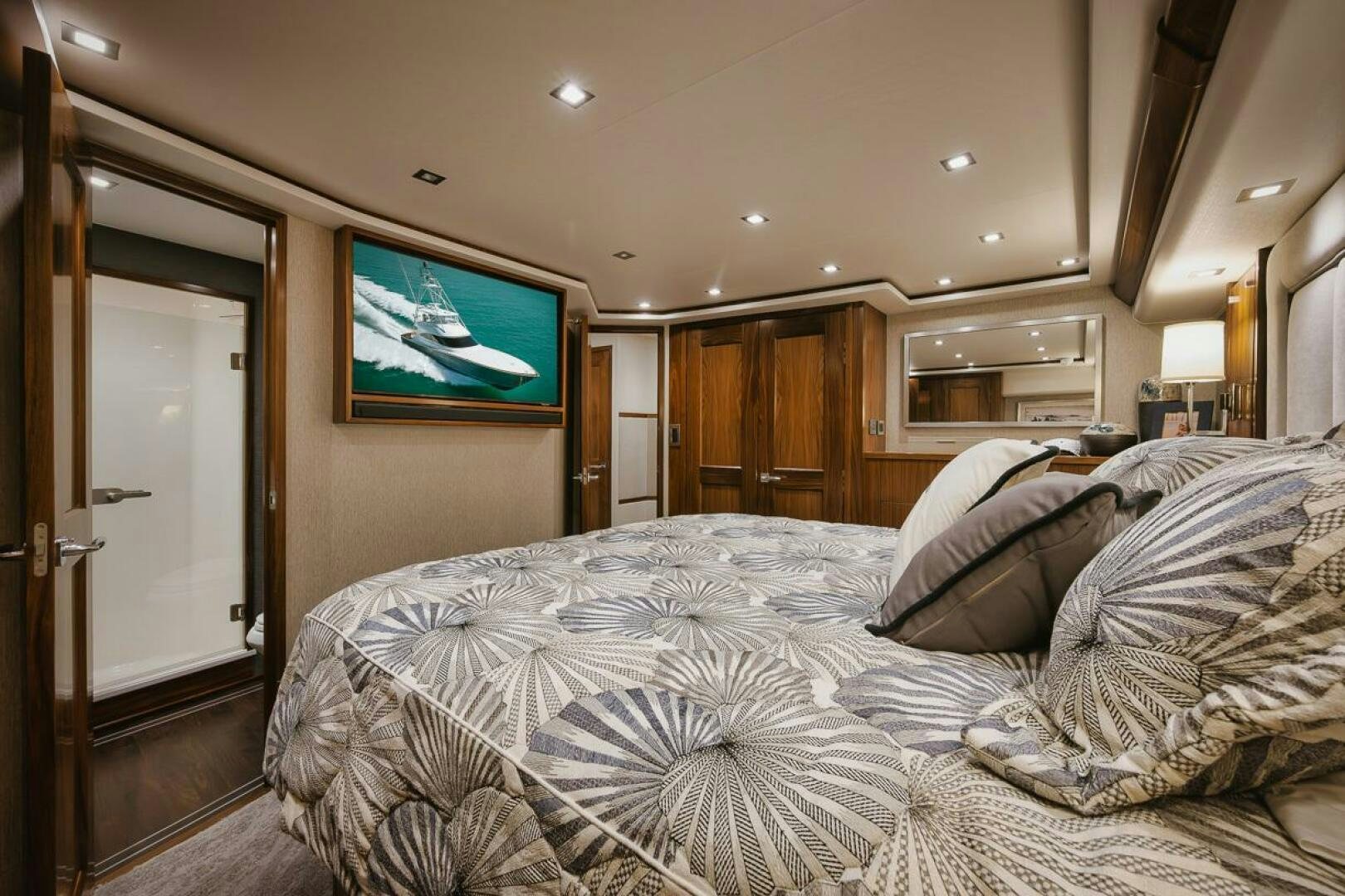 a bed with a television on the wall aboard WHIRLWIND Yacht for Sale