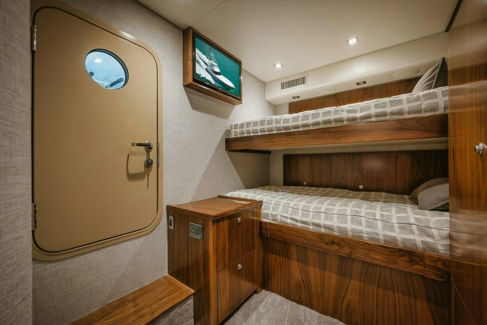 a room with a bed and a tv on the wall aboard WHIRLWIND Yacht for Sale