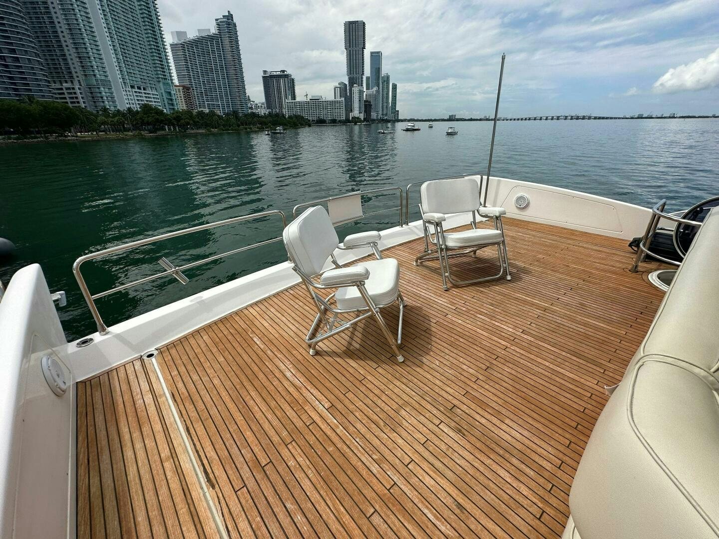 a deck with chairs and a body of water in the background aboard SEVEN Yacht for Sale