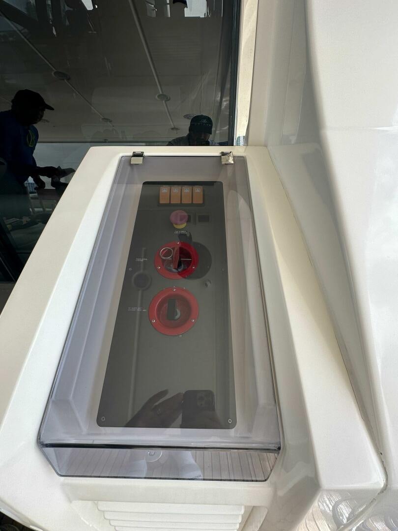 a white rectangular object with a red circle and a black circle on it aboard SEVEN Yacht for Sale