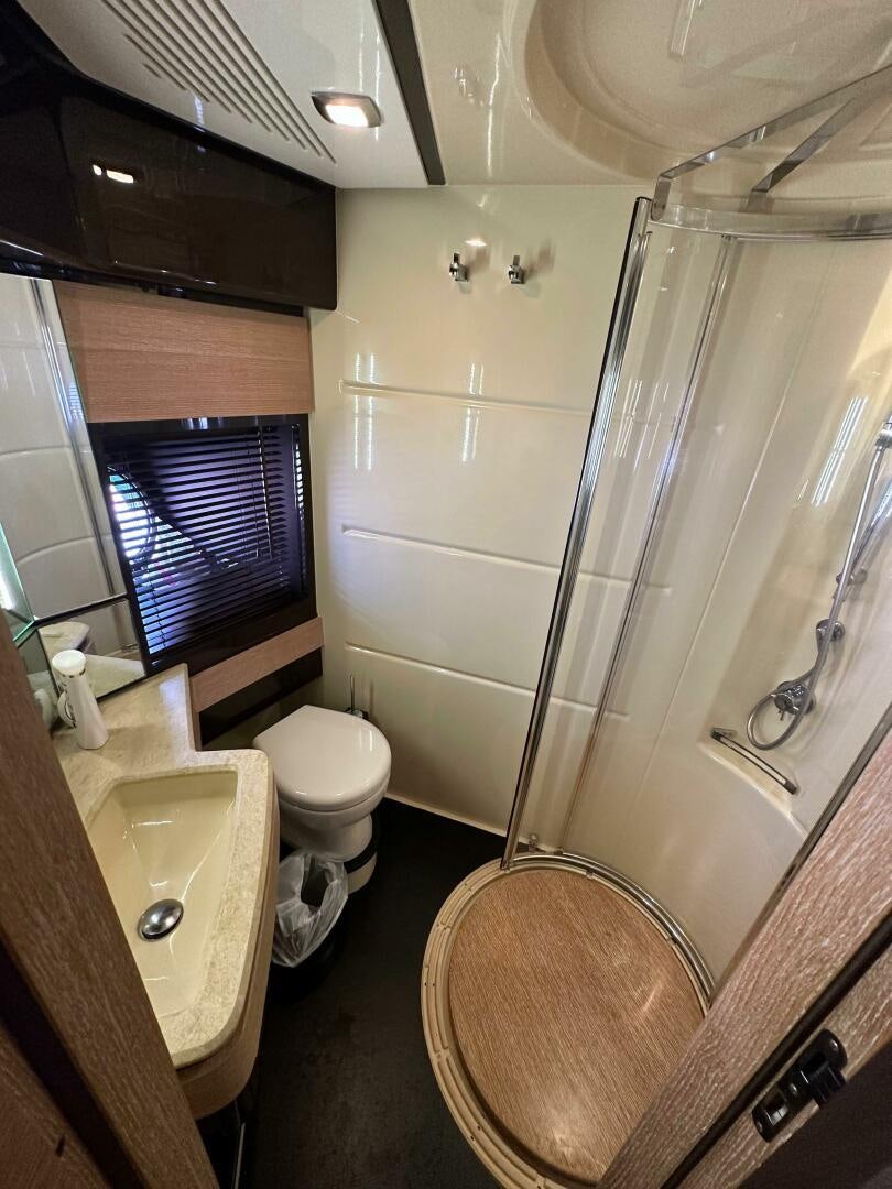 a bathroom with a glass shower aboard SEVEN Yacht for Sale