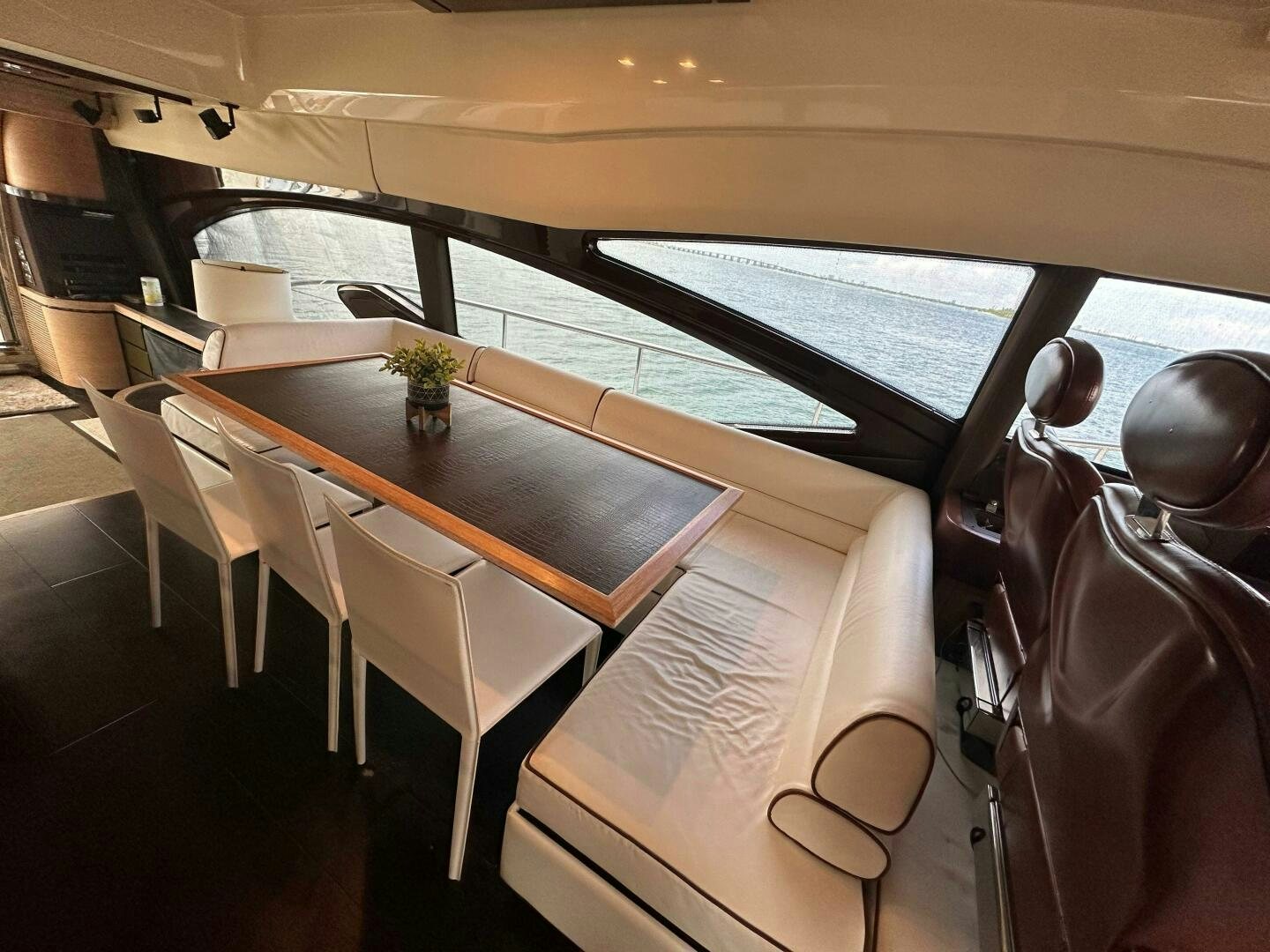 a room with a table and chairs aboard SEVEN Yacht for Sale