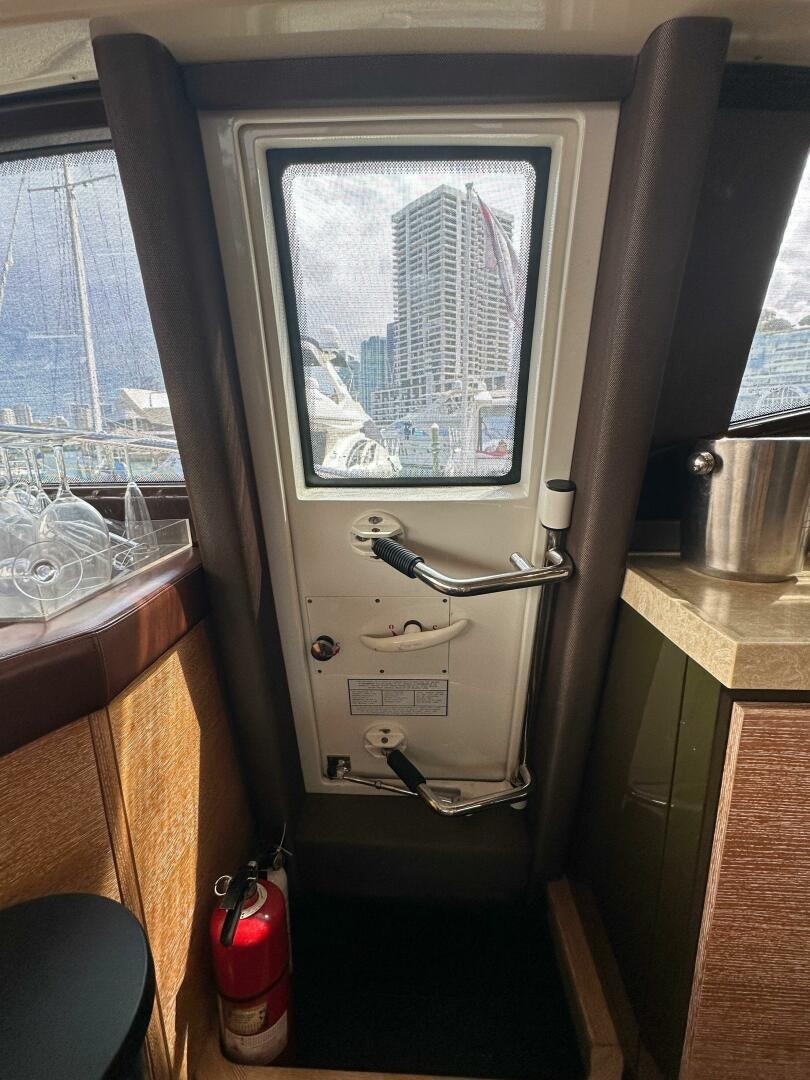 a window with a view of a city aboard SEVEN Yacht for Sale