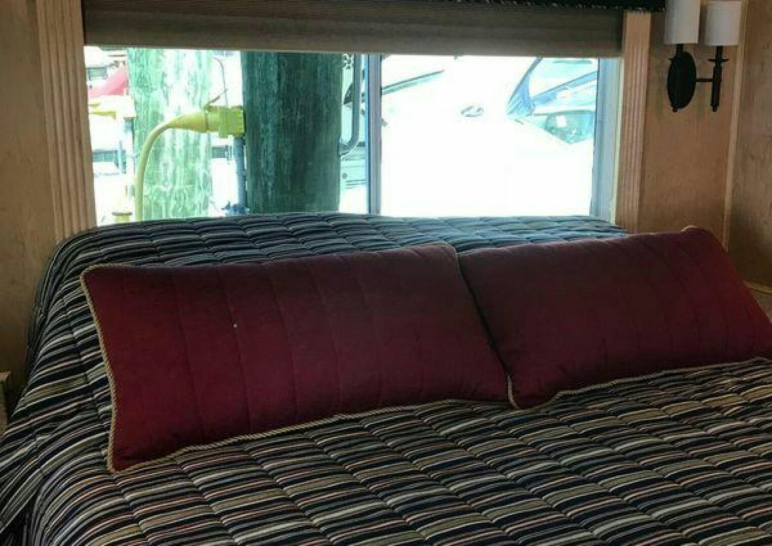 a couch with a window aboard ST. SOMEWHERE Yacht for Sale