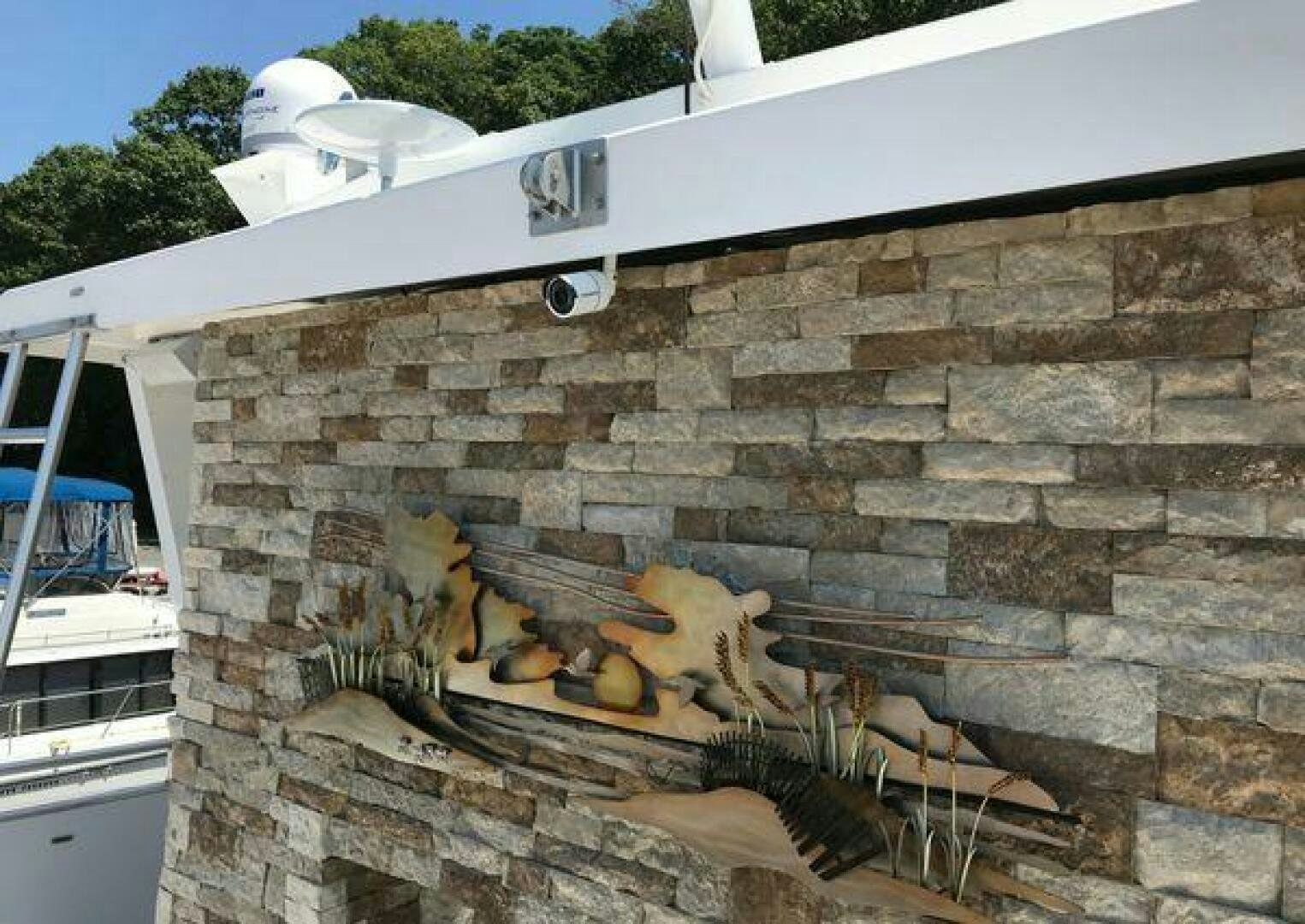 a stone wall with a stone wall and a large fire aboard ST. SOMEWHERE Yacht for Sale