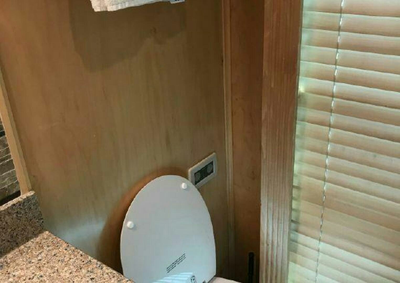 a toilet in a wooden room aboard ST. SOMEWHERE Yacht for Sale