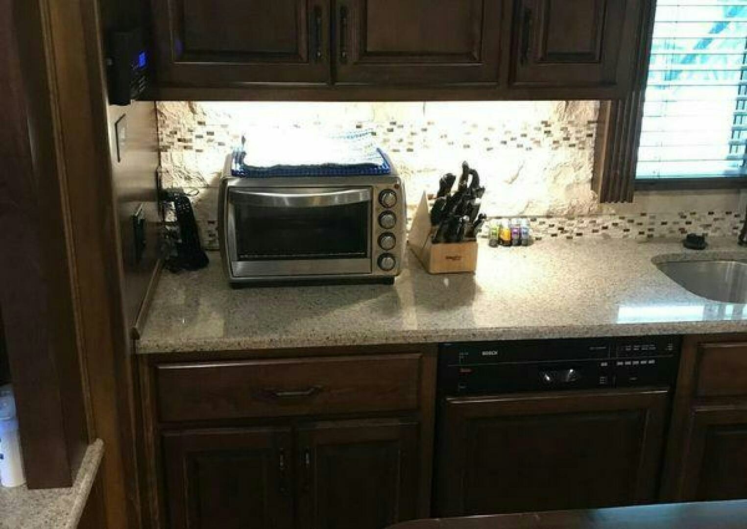 a microwave oven sits on top of a counter top aboard ST. SOMEWHERE Yacht for Sale
