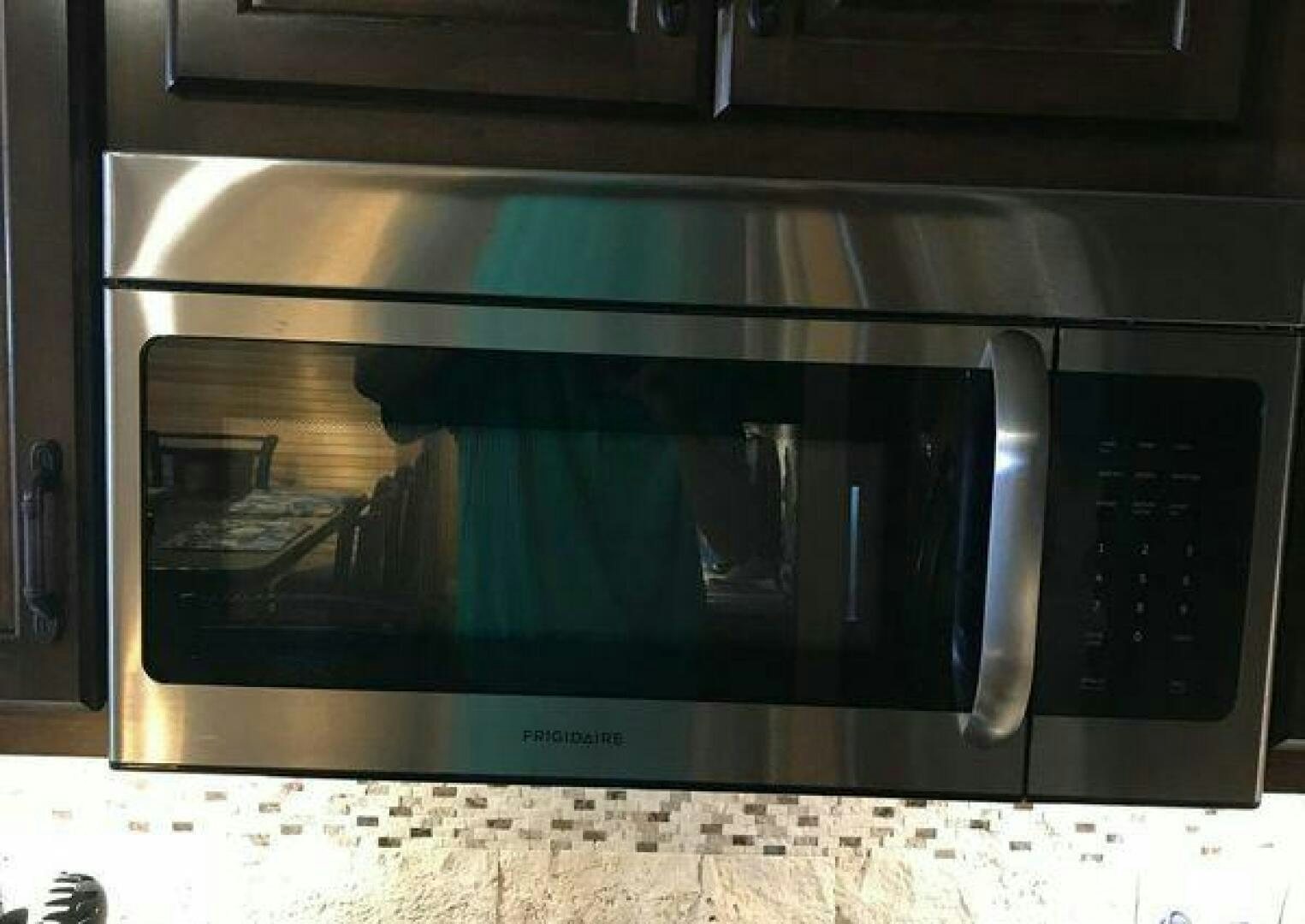 a microwave oven with a person in the oven aboard ST. SOMEWHERE Yacht for Sale