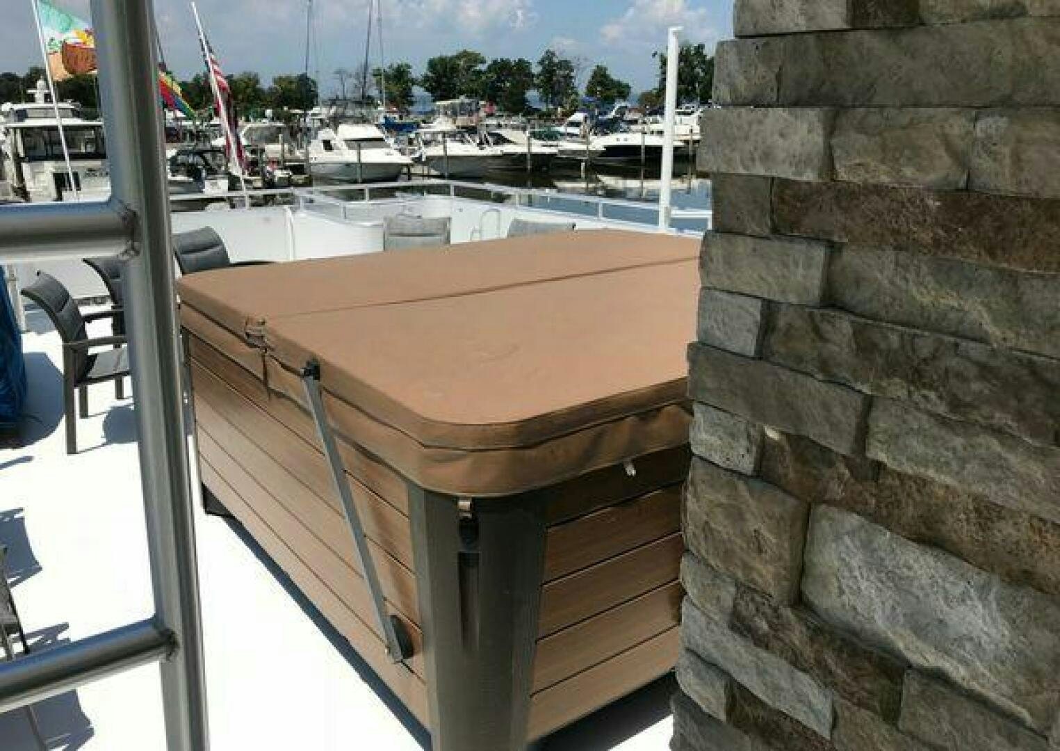 a wooden table on a balcony aboard ST. SOMEWHERE Yacht for Sale
