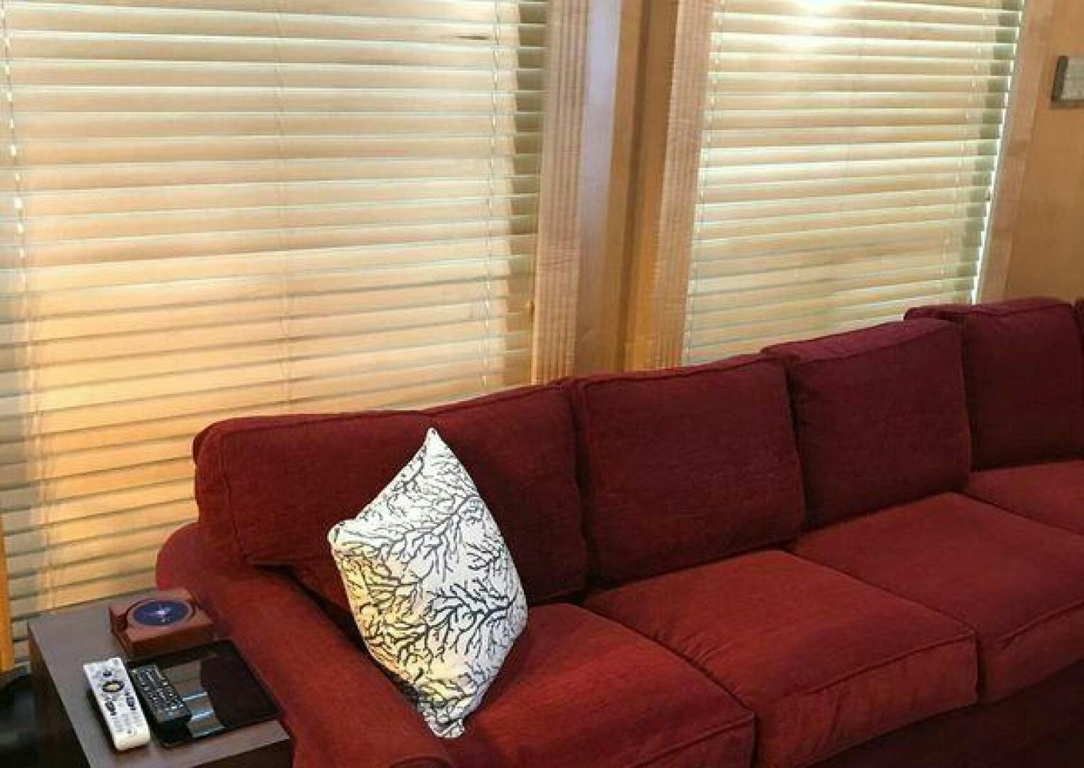 a red couch with a pillow on it aboard ST. SOMEWHERE Yacht for Sale
