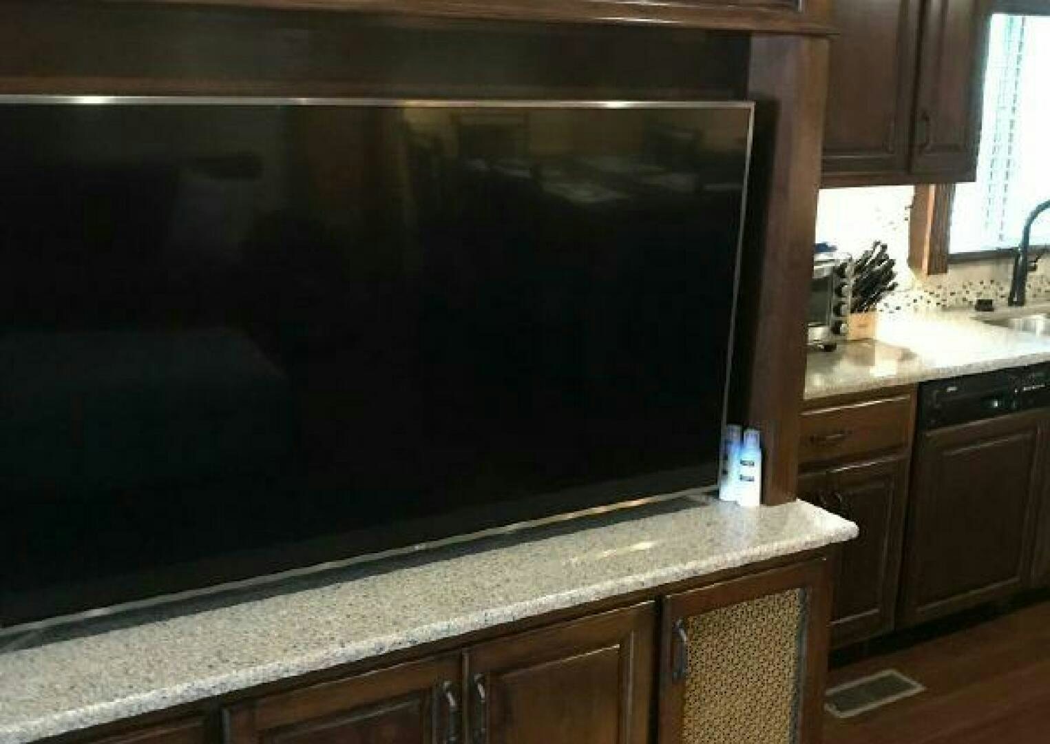 a large television in a kitchen aboard ST. SOMEWHERE Yacht for Sale
