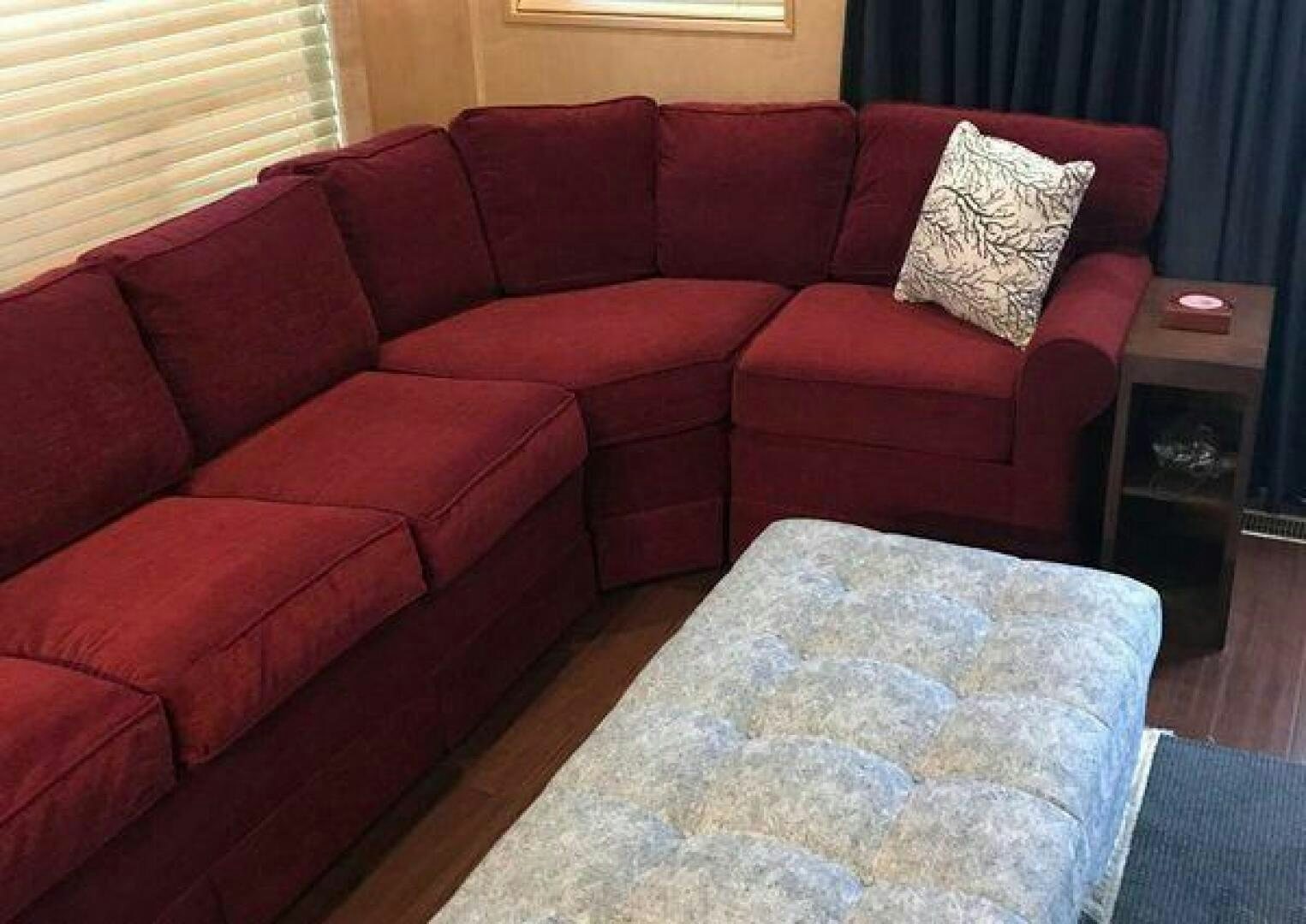 a couch with a pillow on it aboard ST. SOMEWHERE Yacht for Sale