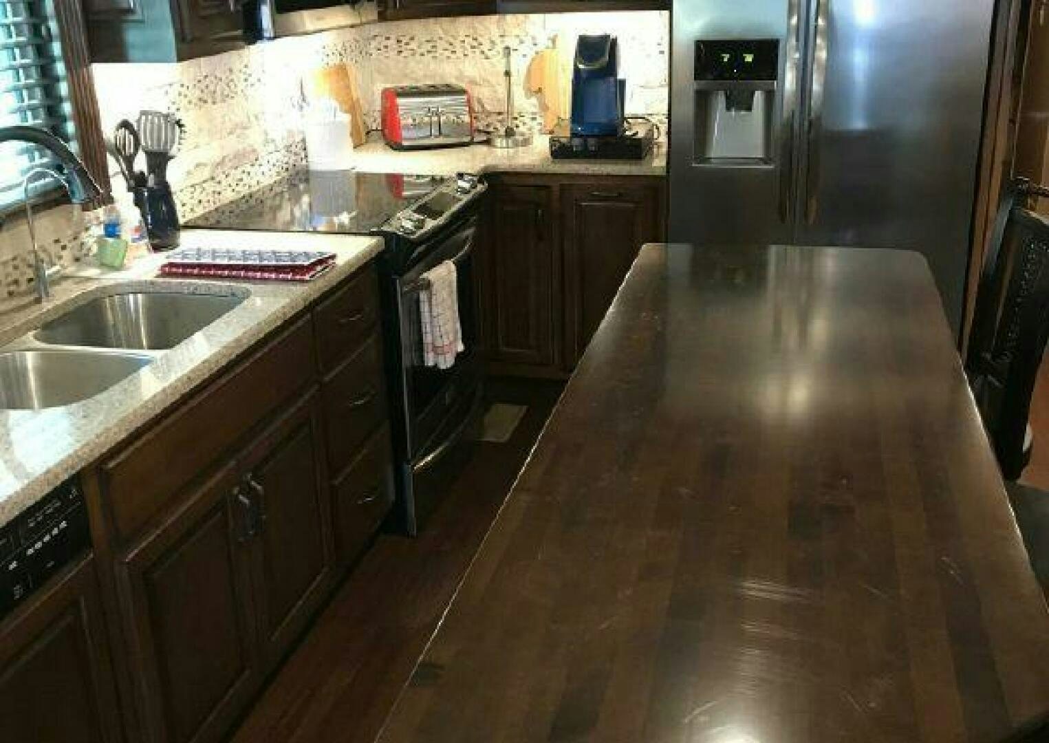 a kitchen with a wood counter aboard ST. SOMEWHERE Yacht for Sale