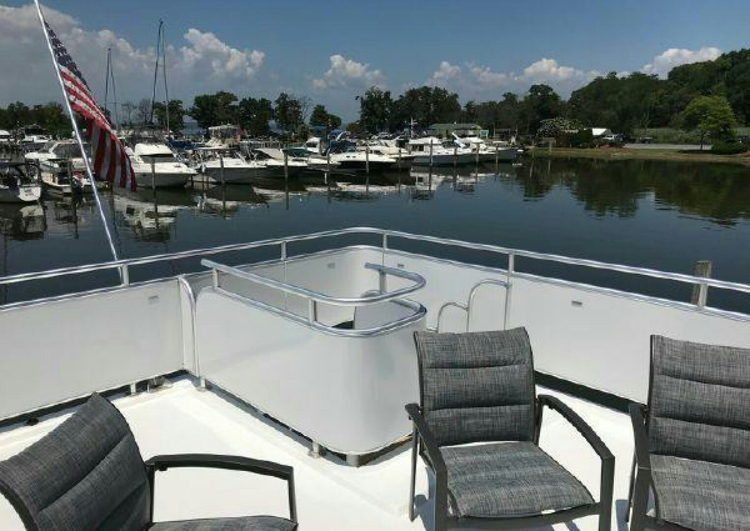 a deck with chairs and a chair on it aboard ST. SOMEWHERE Yacht for Sale