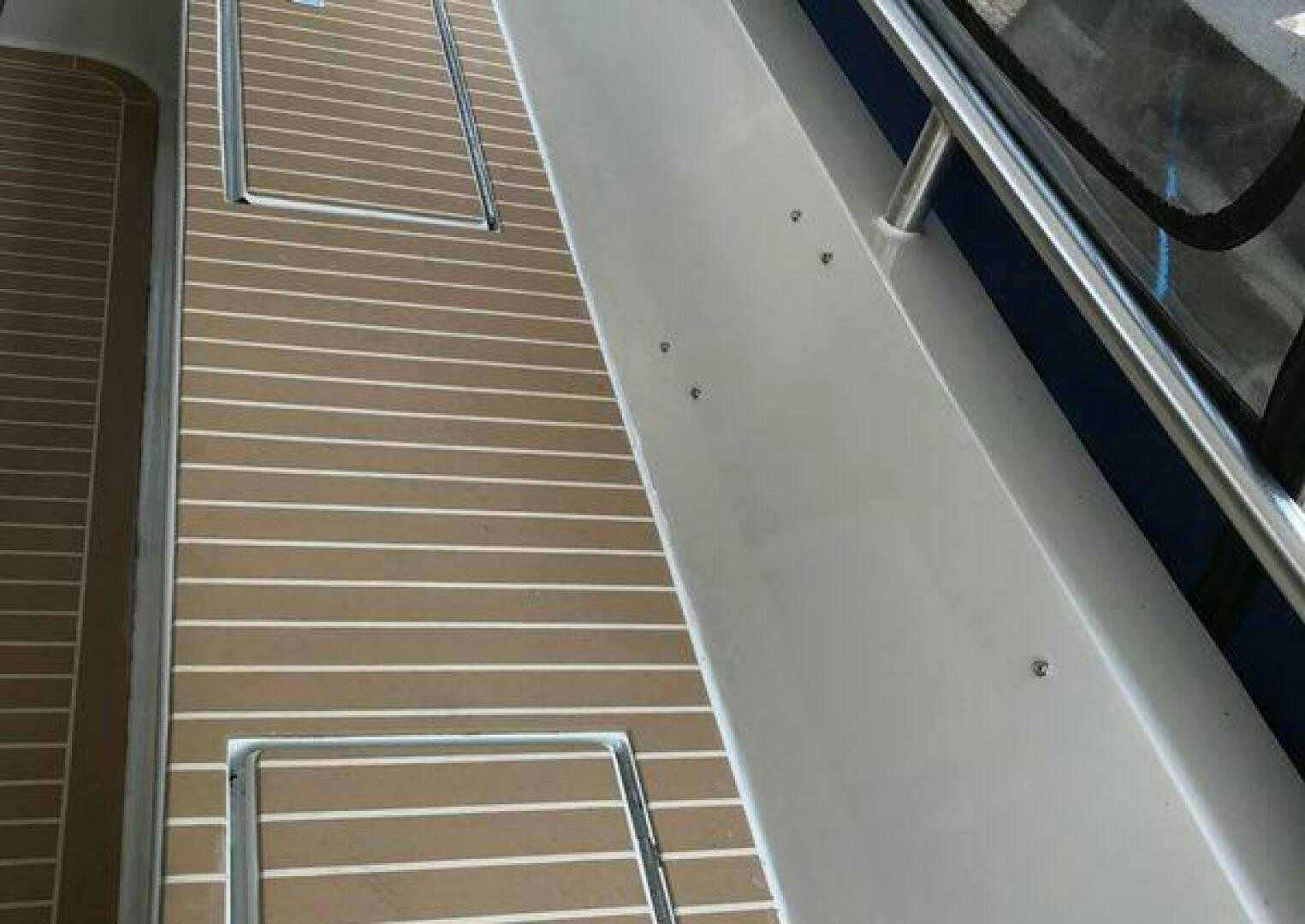 a wooden staircase with a railing aboard ST. SOMEWHERE Yacht for Sale