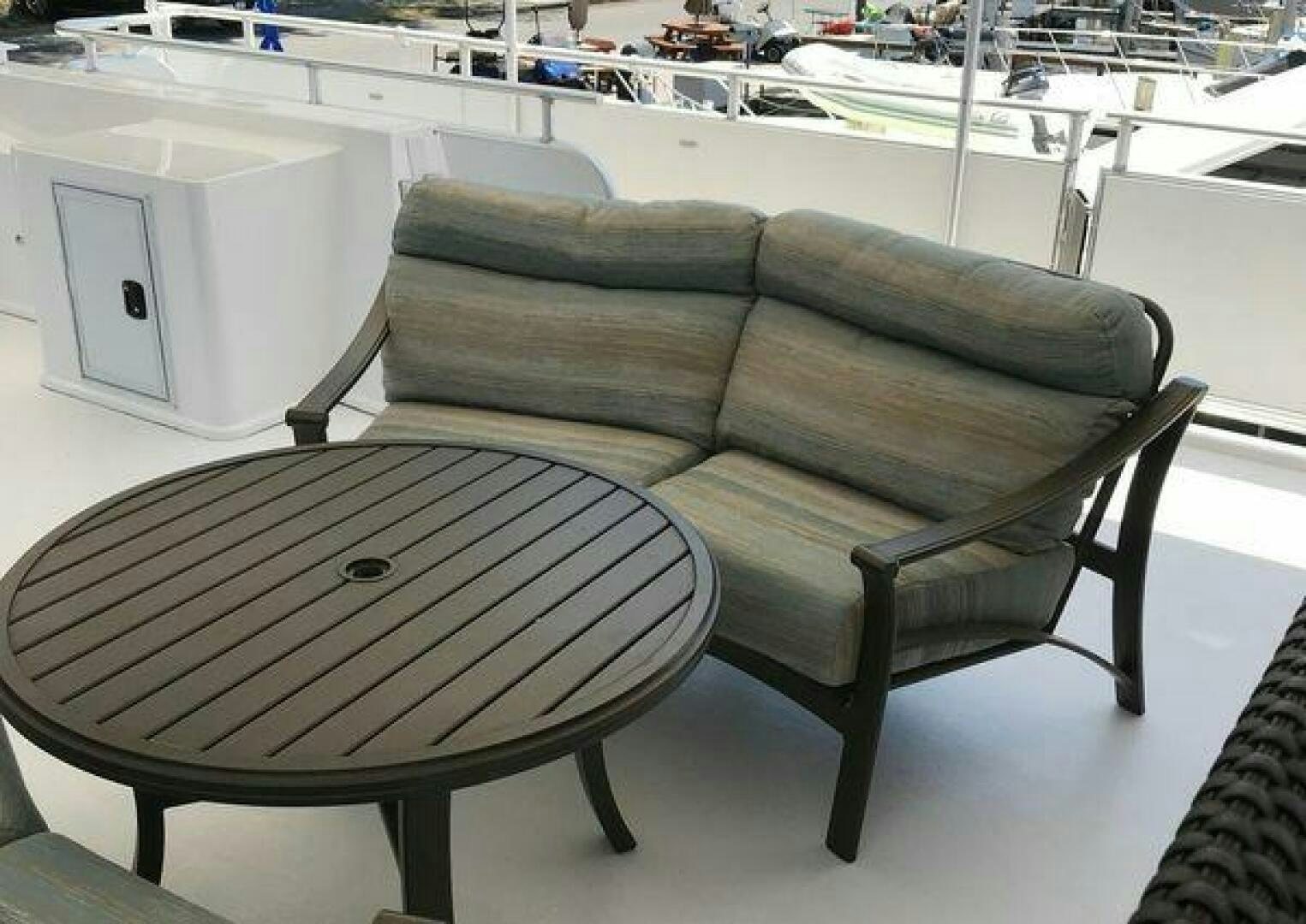 a couch and table in a room aboard ST. SOMEWHERE Yacht for Sale