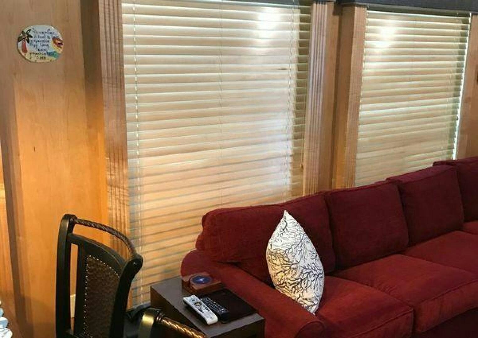 a red couch with a white pillow aboard ST. SOMEWHERE Yacht for Sale