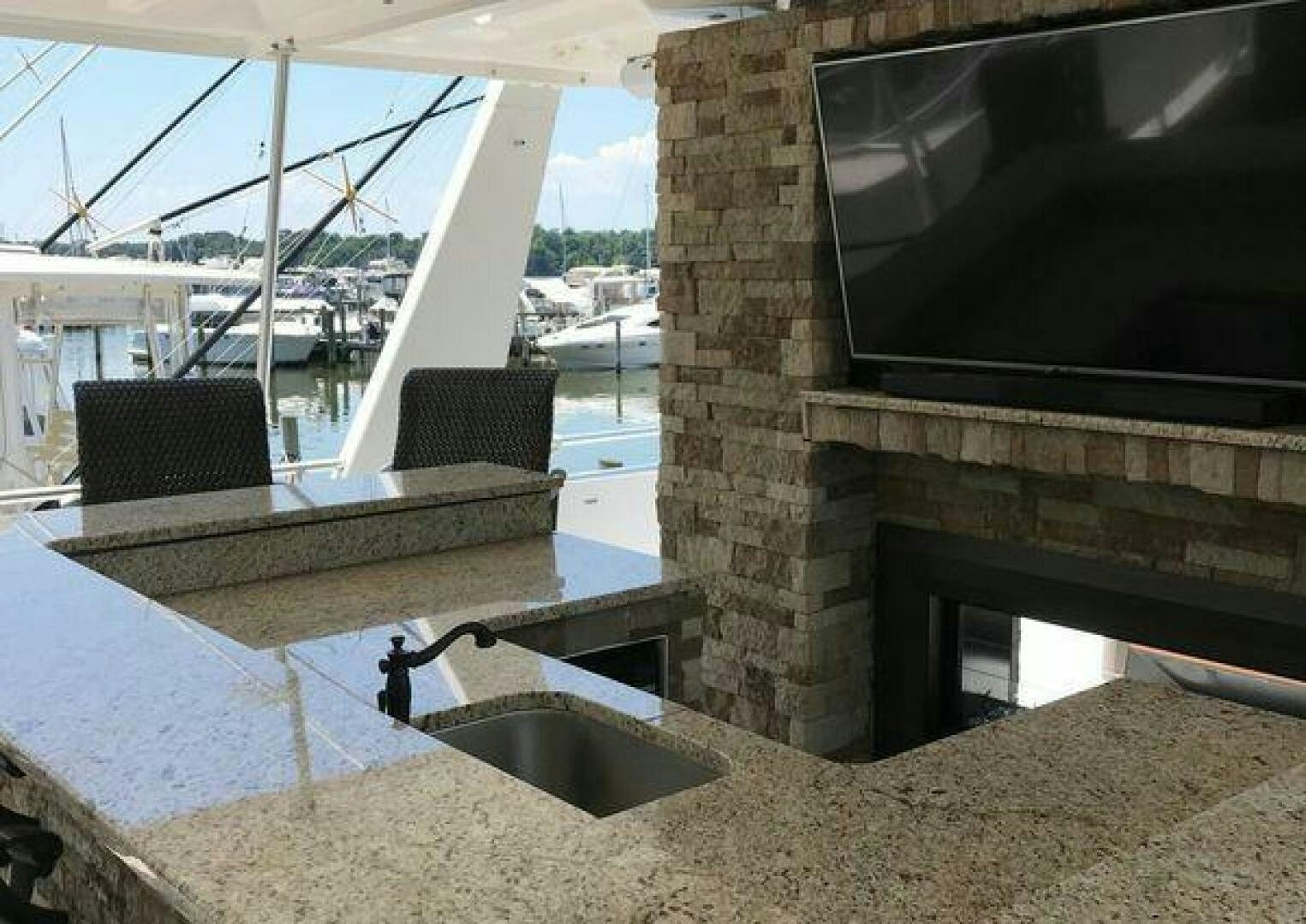 a kitchen with a fireplace aboard ST. SOMEWHERE Yacht for Sale