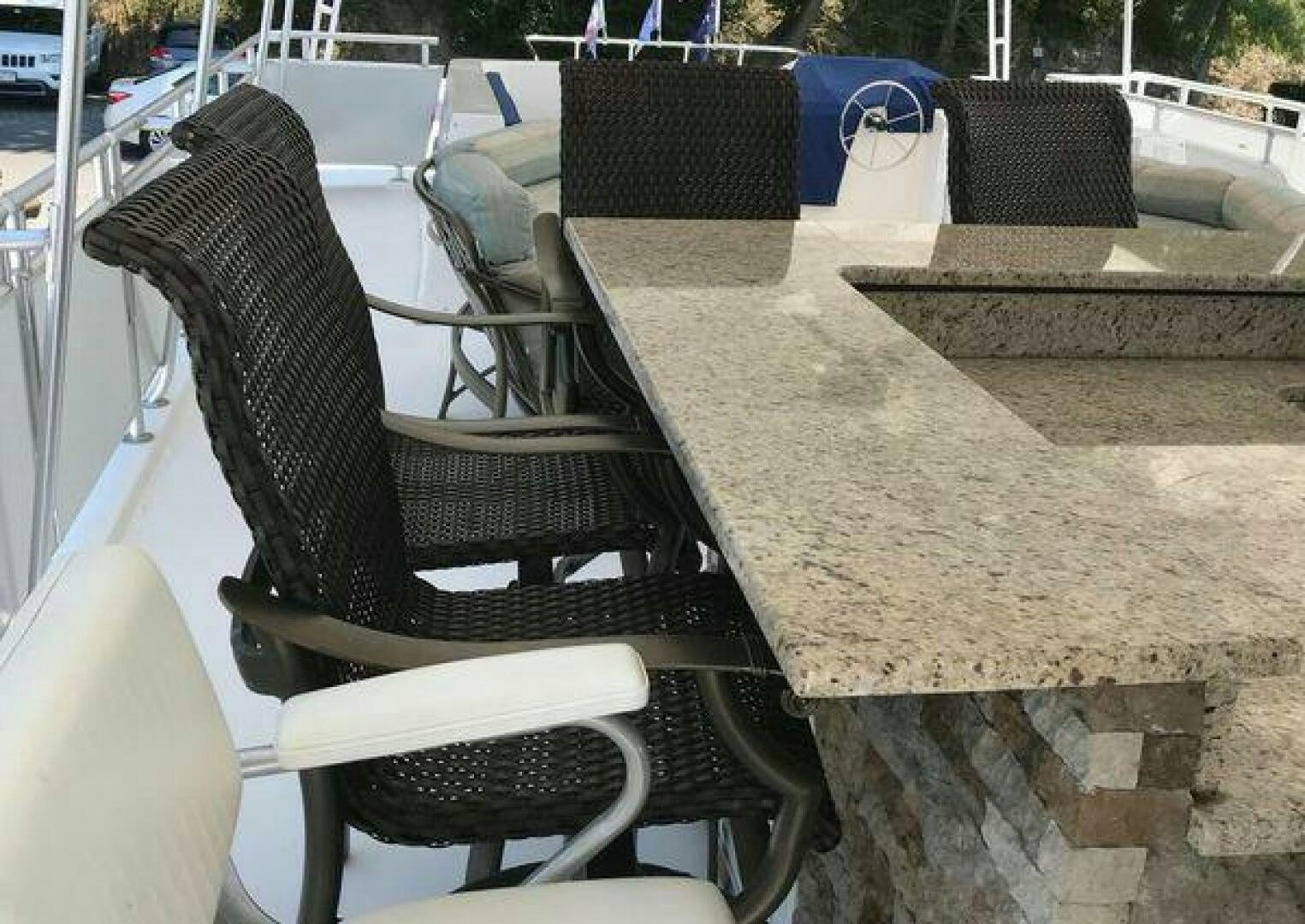 a chair and a table outside aboard ST. SOMEWHERE Yacht for Sale
