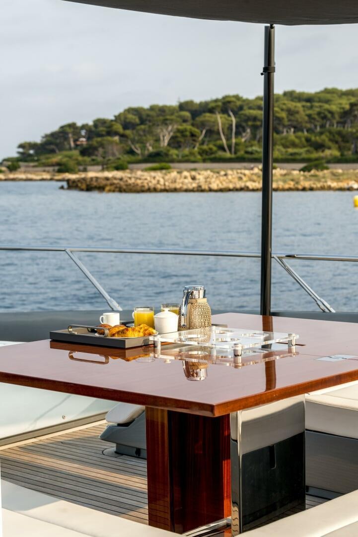 a table with food on it by a body of water aboard GECUA Yacht for Sale