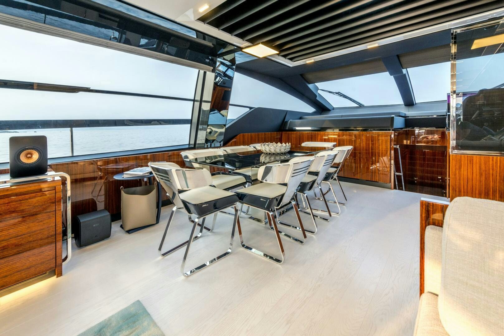 a room with tables and chairs aboard GECUA Yacht for Sale